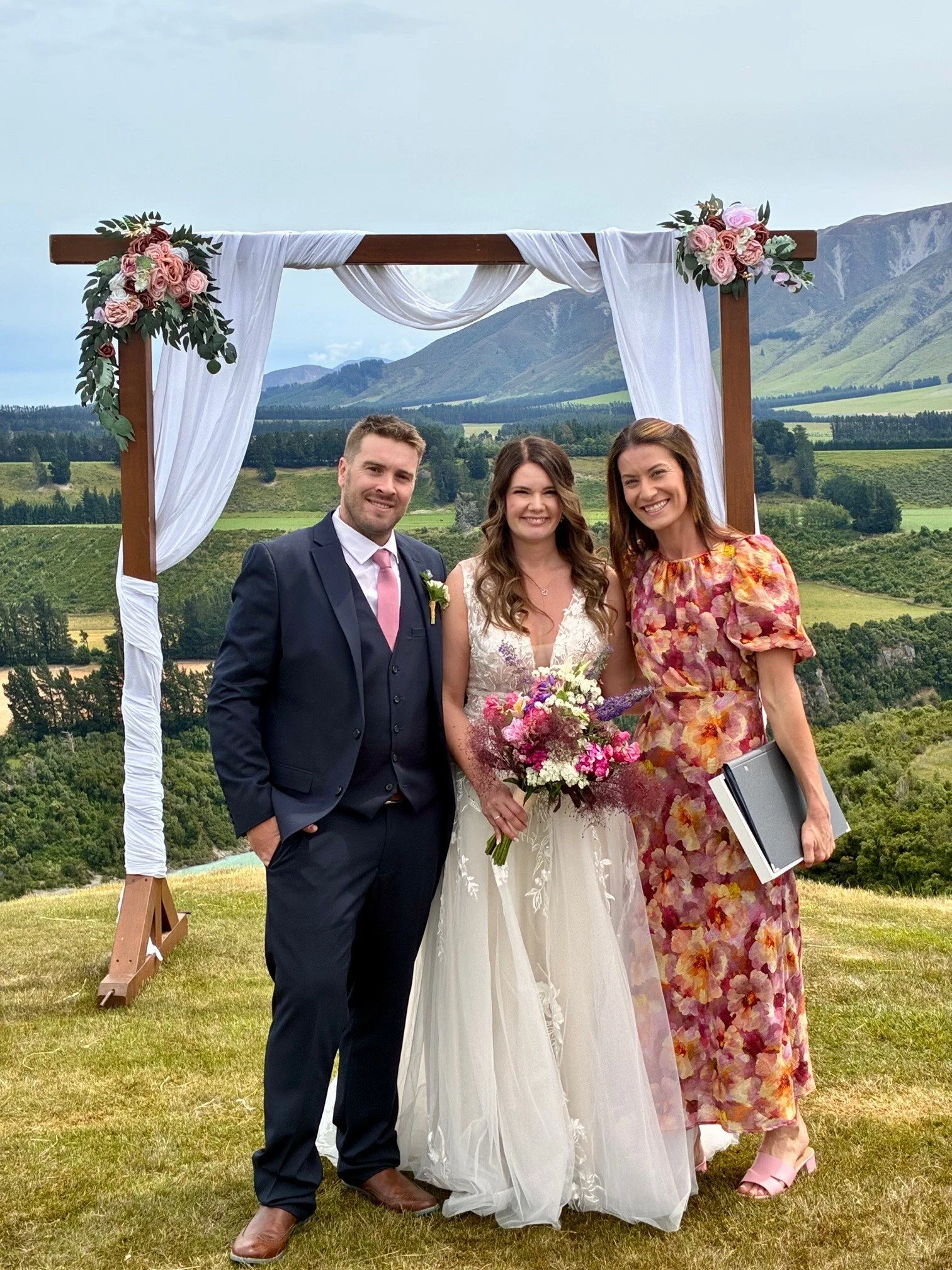 Celebrant Ollie van der Pol with a couple after their wedding ceremony at Terrace Downs Golf Course near Rakaia Gorge