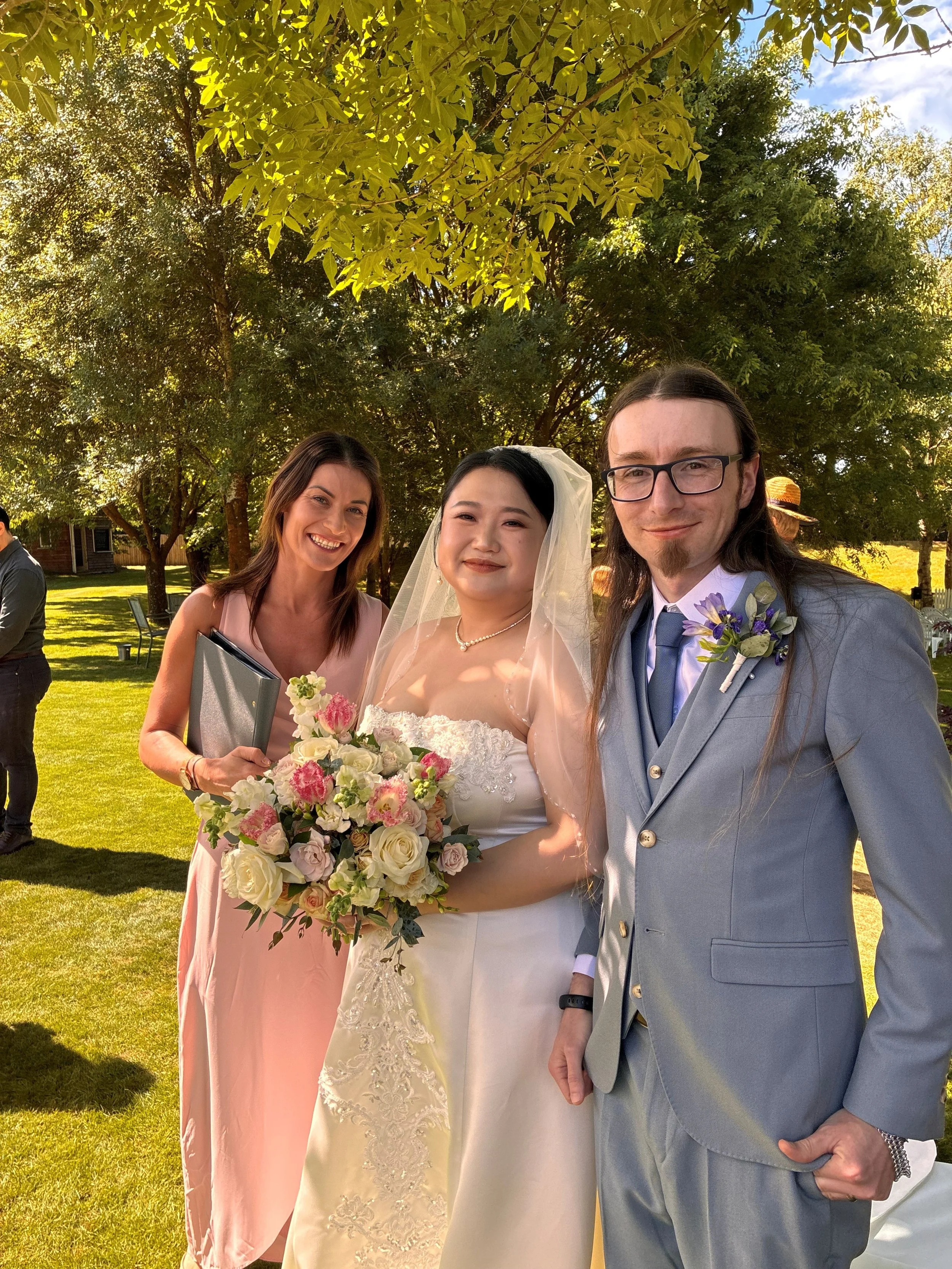 Bride and groom during their wedding ceremony at The Vines Club with celebrant Ollie van der Pol.
