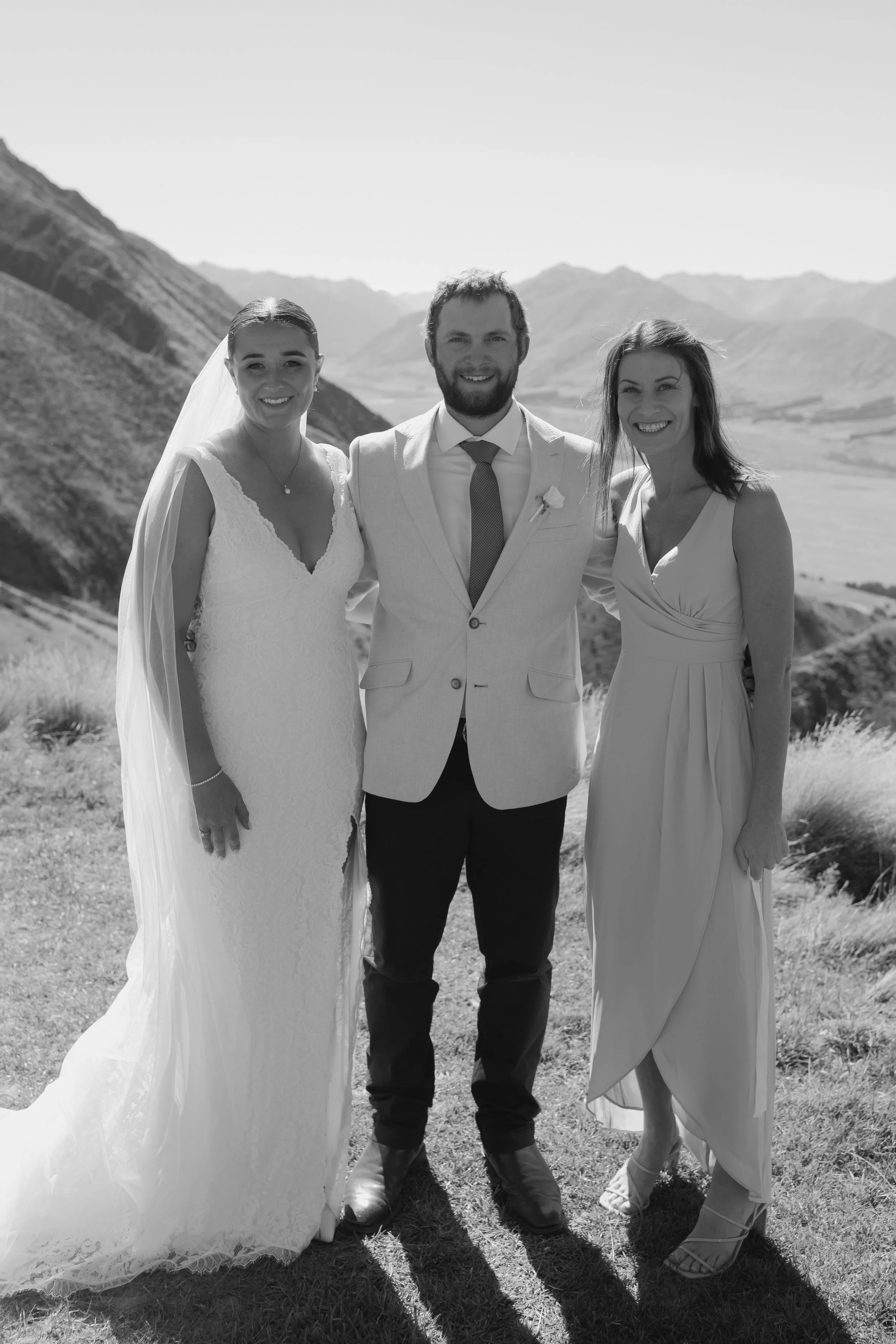 Celebrant Ollie van der Pol with a newly married couple overlooking Rakaia Gorge and the Canterbury Alps.