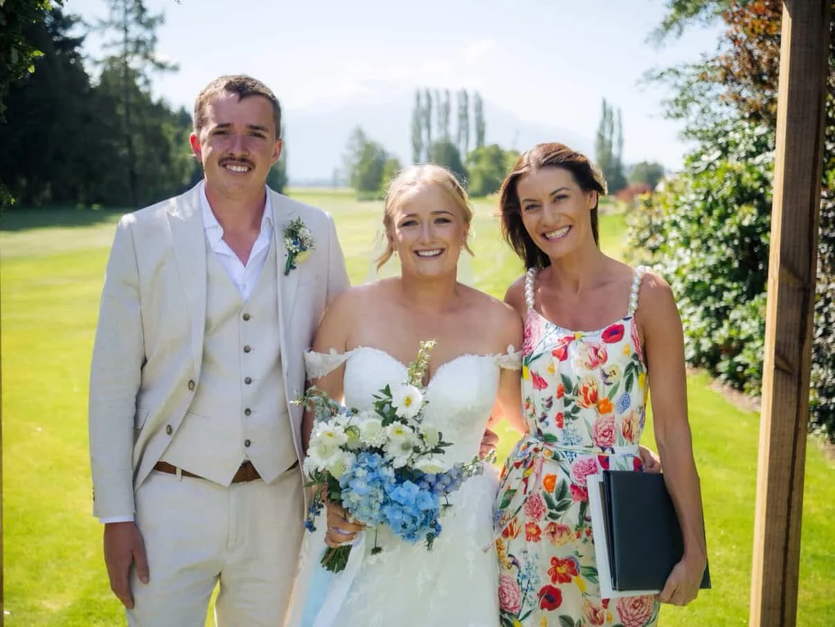 Ollie, celebrant, celebrating with a couple during an outdoor wedding at Methven Golf Course, with Southern Alps views