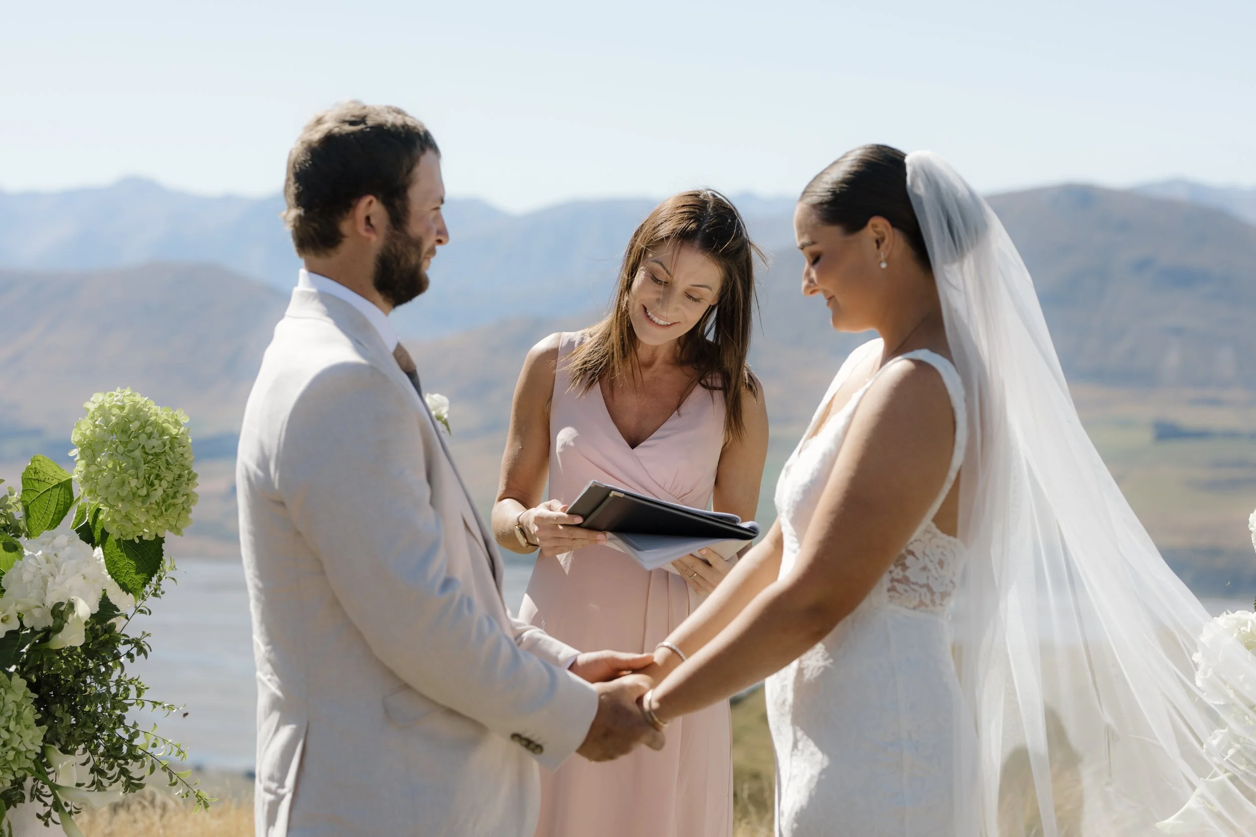 Celebrant Ollie van der Pol with a couple during their legal vows at their wedding in Methven.