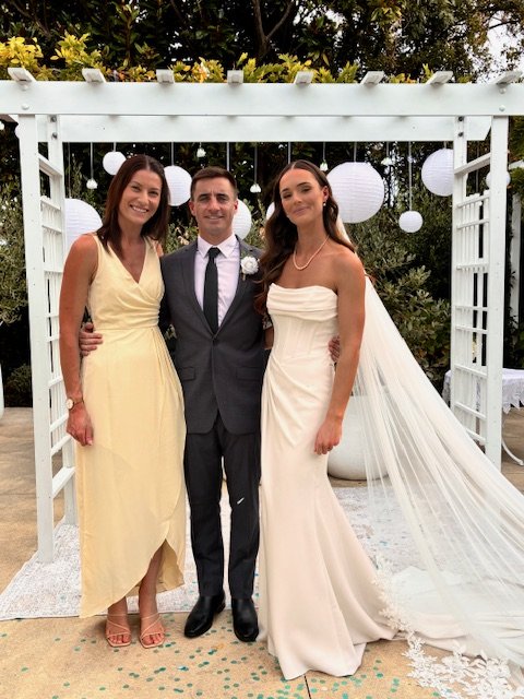 Celebrant Ollie van der Pol with a couple after their wedding ceremony at a private residence in Rangiora.