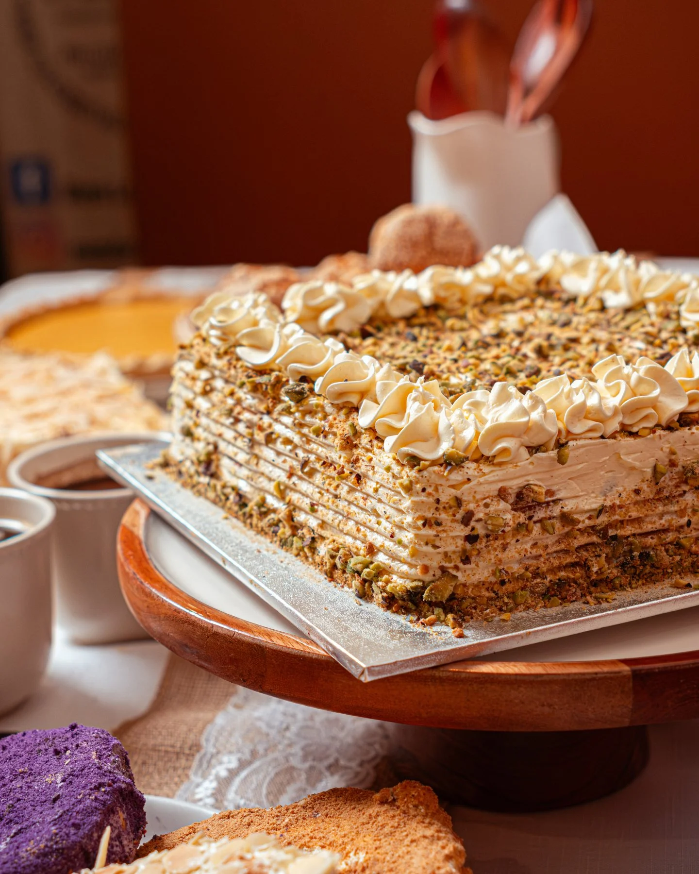 Our Almond Sans Rival is a Filipino classic made with delicate meringue layers, creamy butter filling, and a generous coating of roasted almonds and pistachios. Light, crisp, and perfectly balanced in sweetness.

The kind of dessert that always disap