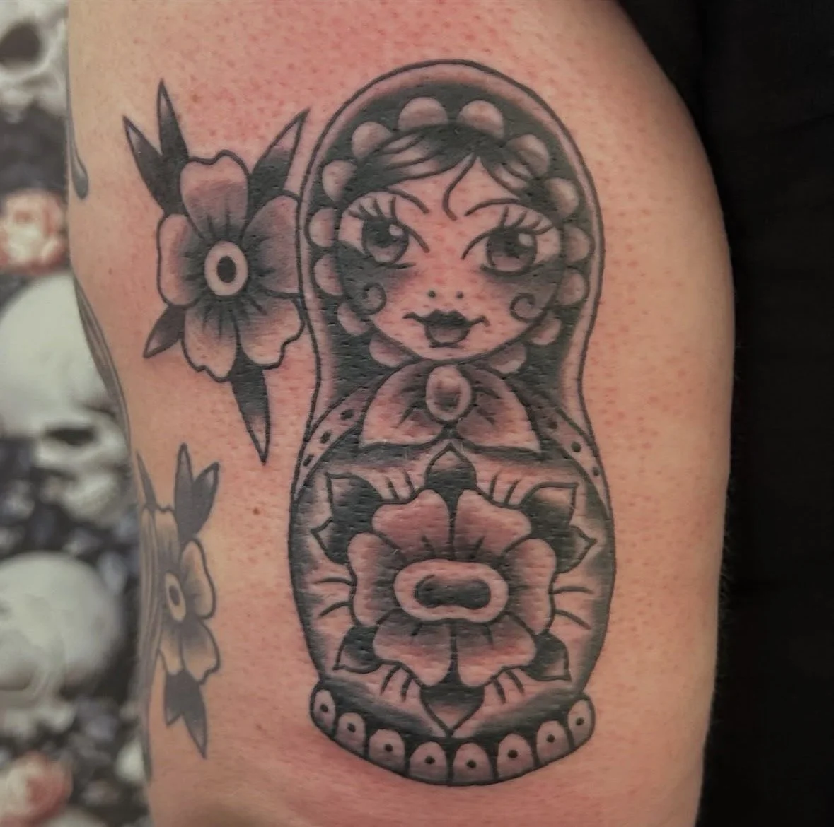 Tattoo of a babushka  on a person's arm.