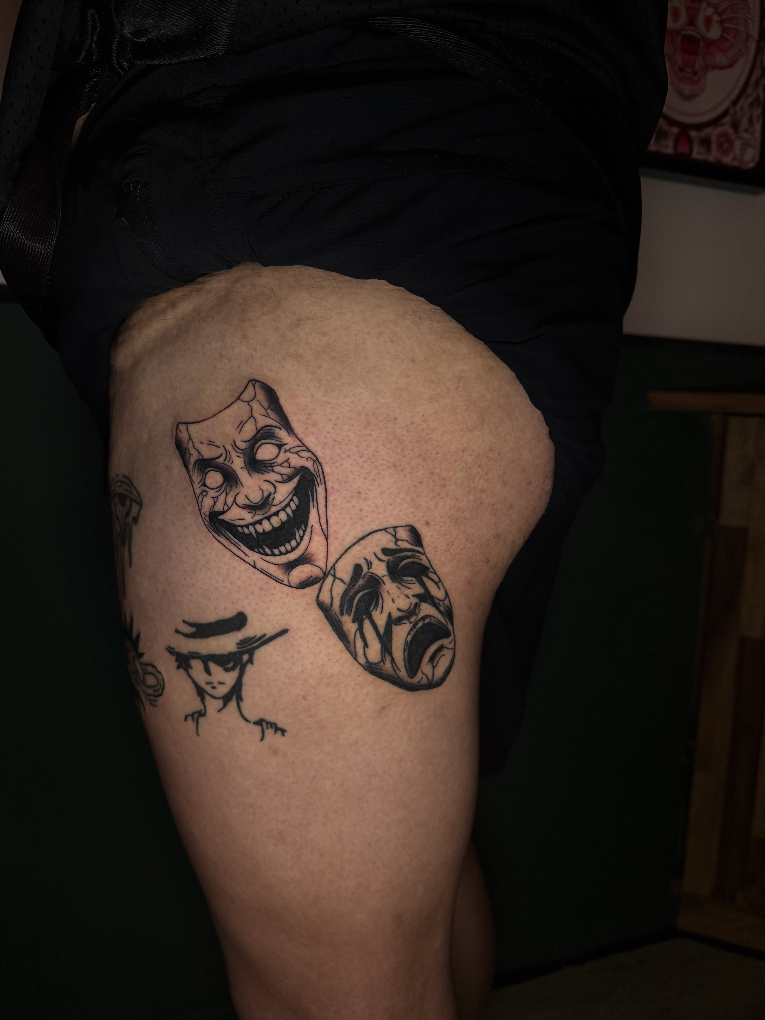 Tattoo of a clown face.