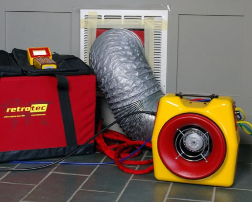 Duct leakage testing setup showing calibrated fan connected to supply register