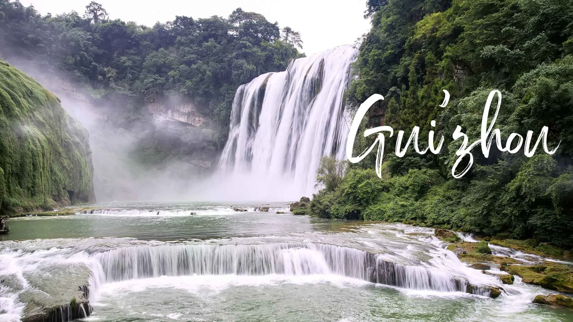 Waterfall in a lush green forest with the word 'Guanzhou' written across the image.