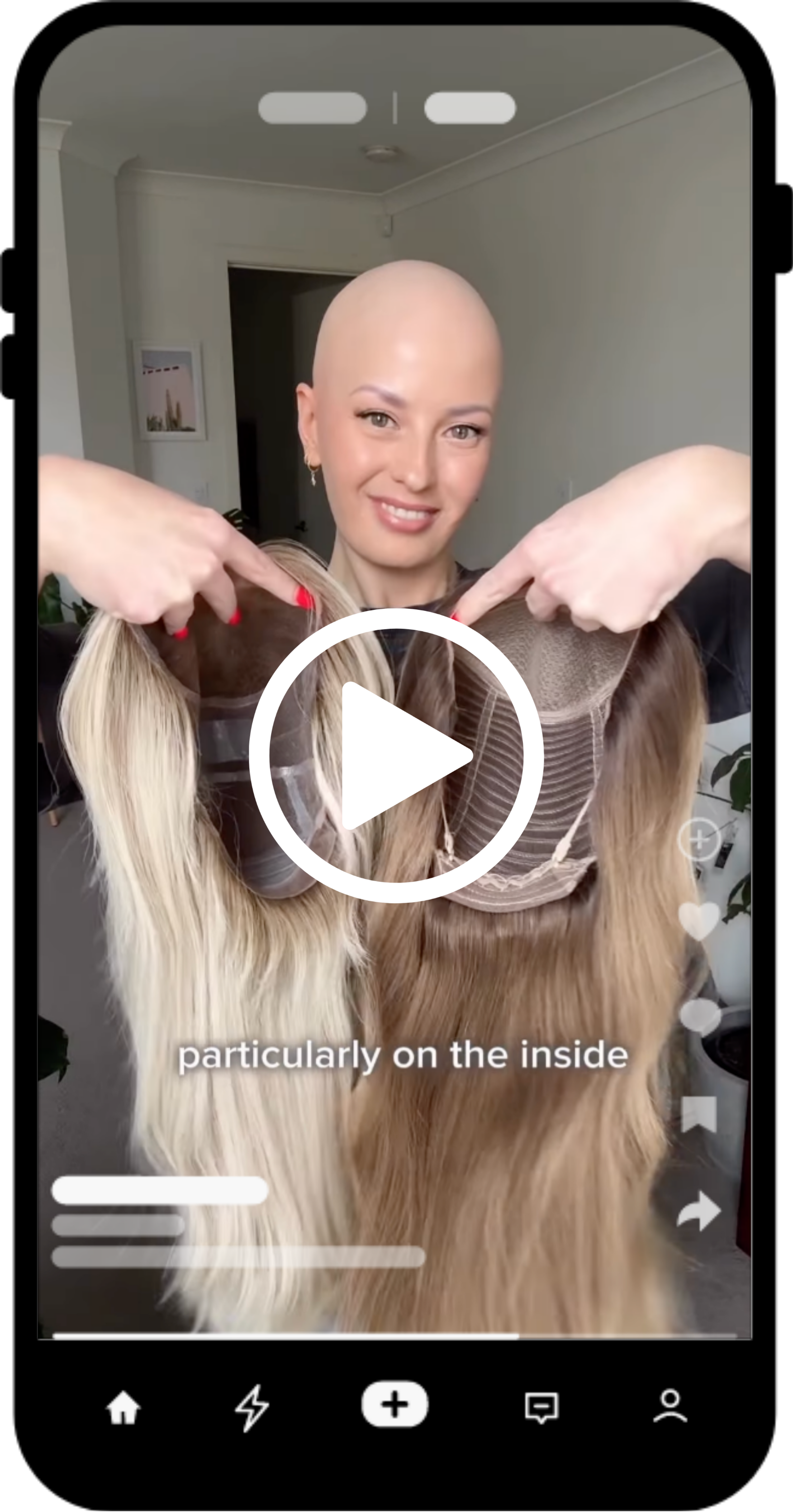 A woman with a shaved head holding two hairpieces with different hair colors, pointing at the inside of each hairpiece.