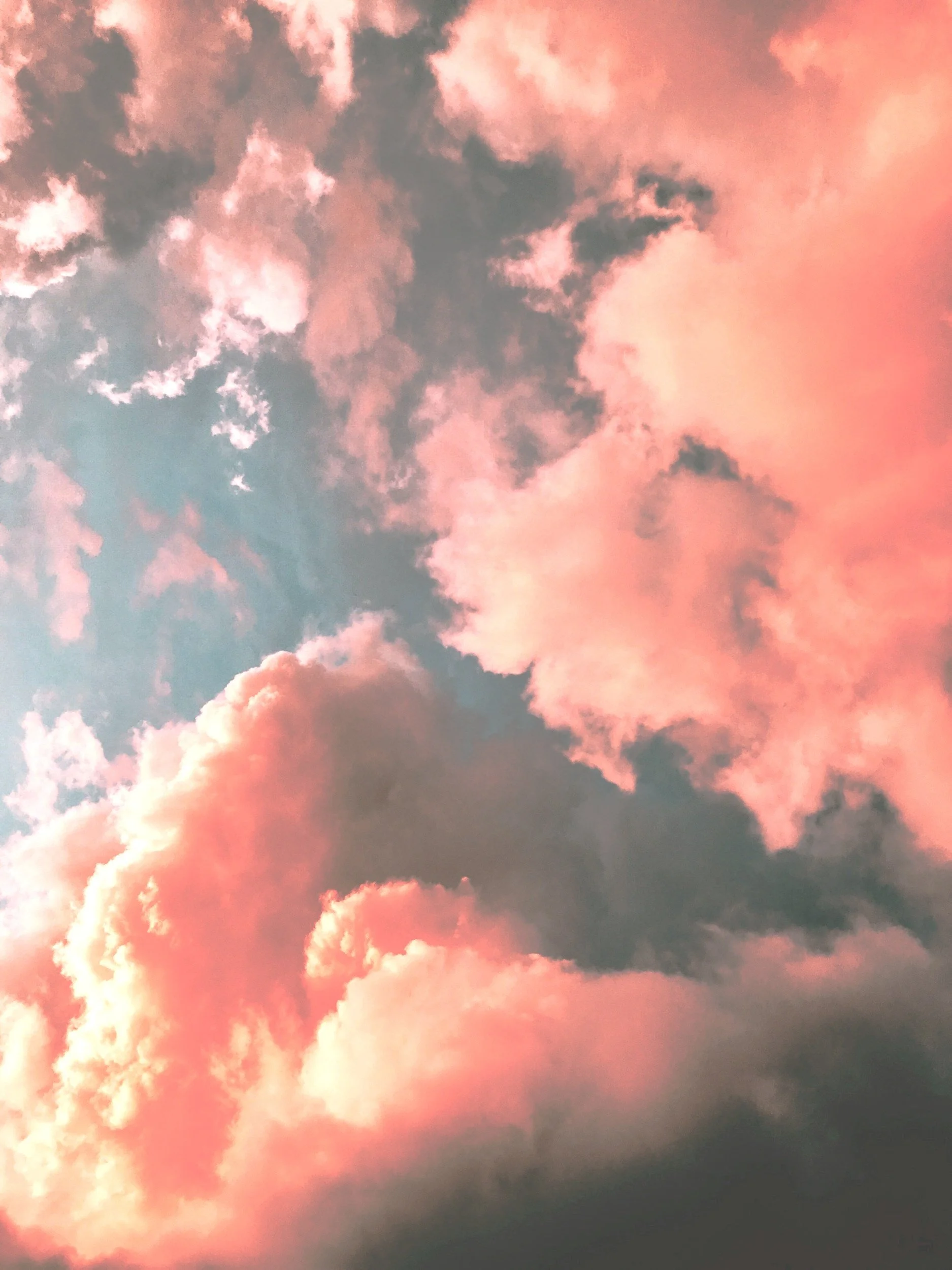 Sky with pink and dark clouds at sunset.