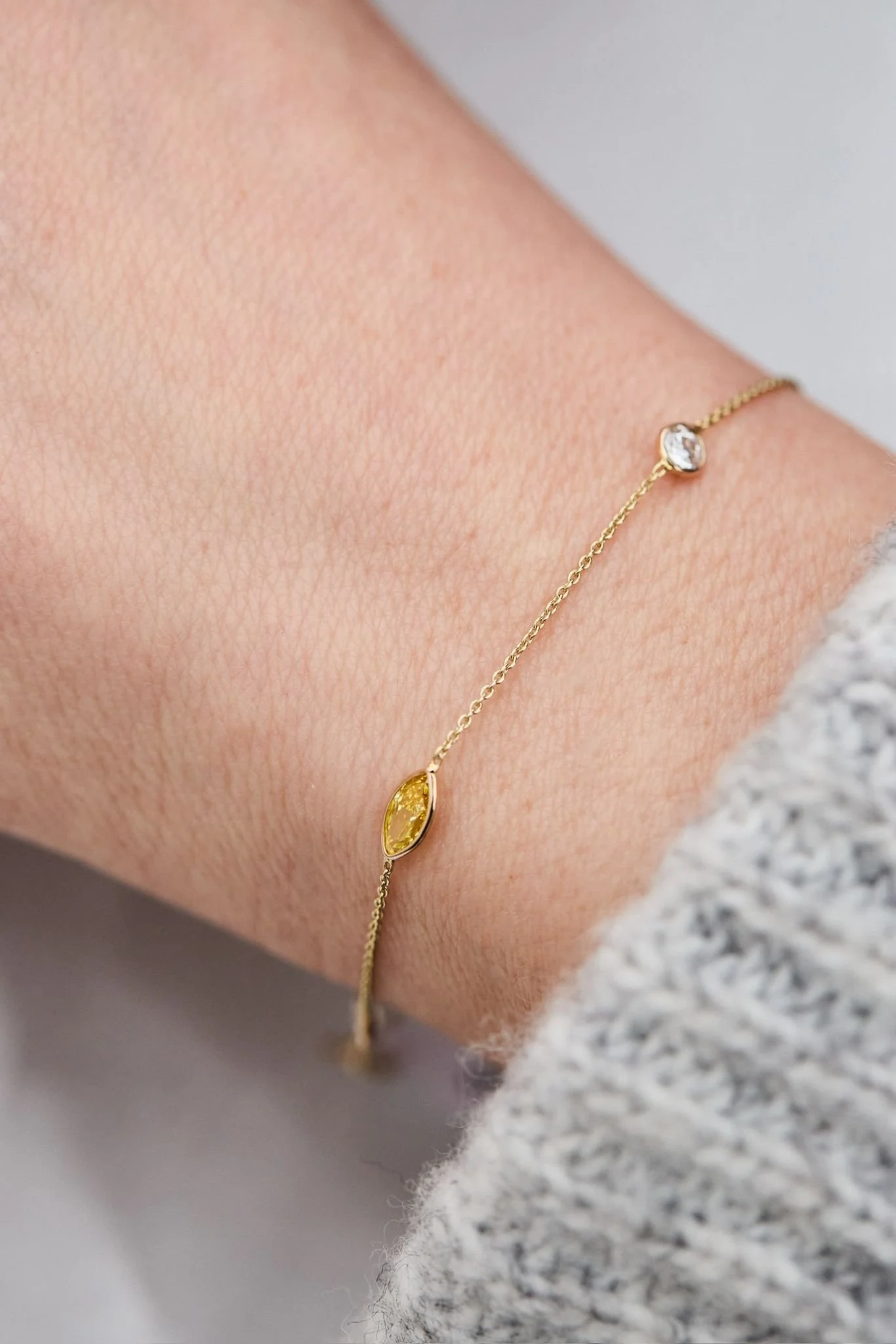 Yellow marquise cut diamond bracelet with round cut diamond bezel