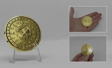 Close-up of a gold-colored coin with a skull design, displayed on a stand and shown in hands from different angles.