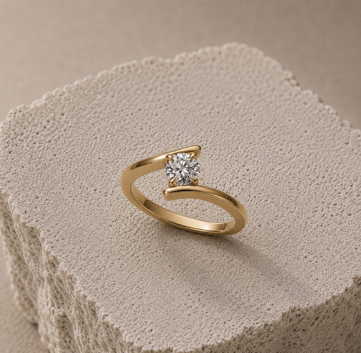 Bespoke 1ct GIA-certified round brilliant diamond Crossover engagement ring handmade in 18ct yellow gold by Hatton Garden jeweller Daniel Greenberg.