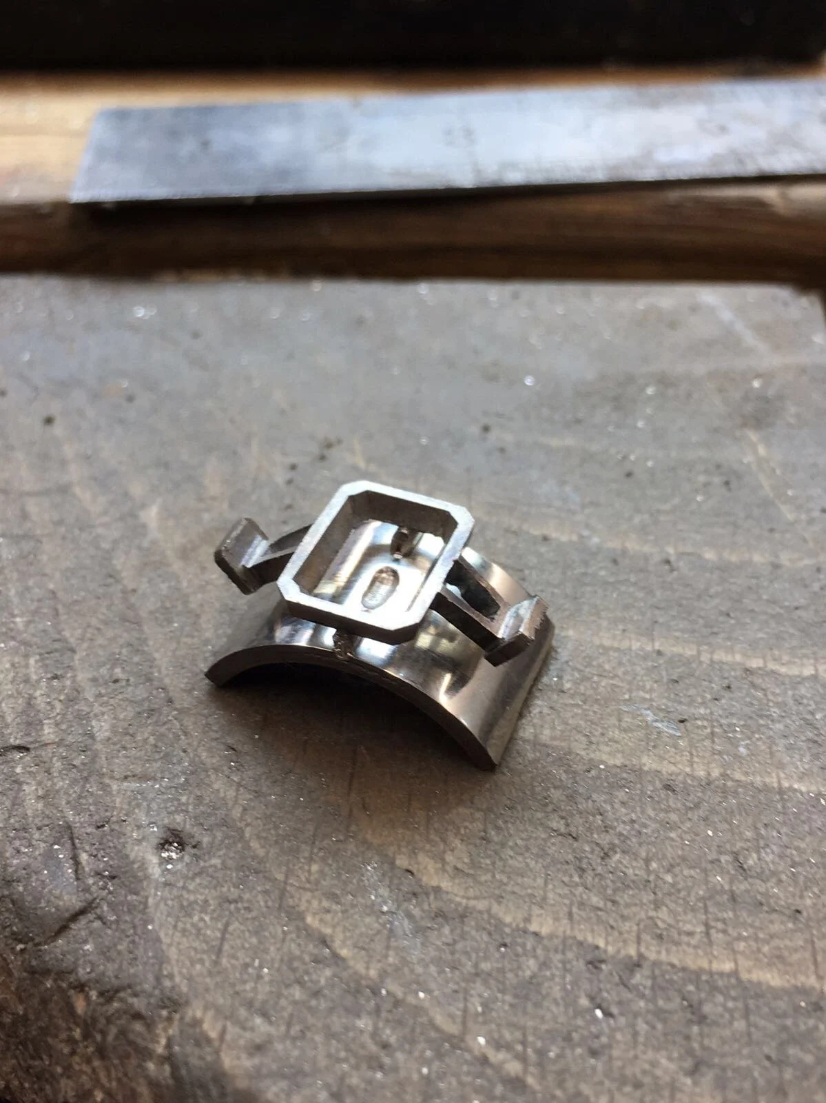 Daniel crafting platinum 3 carat emerald-cut diamond ring with tapered baguettes in Hatton Garden London workshop.