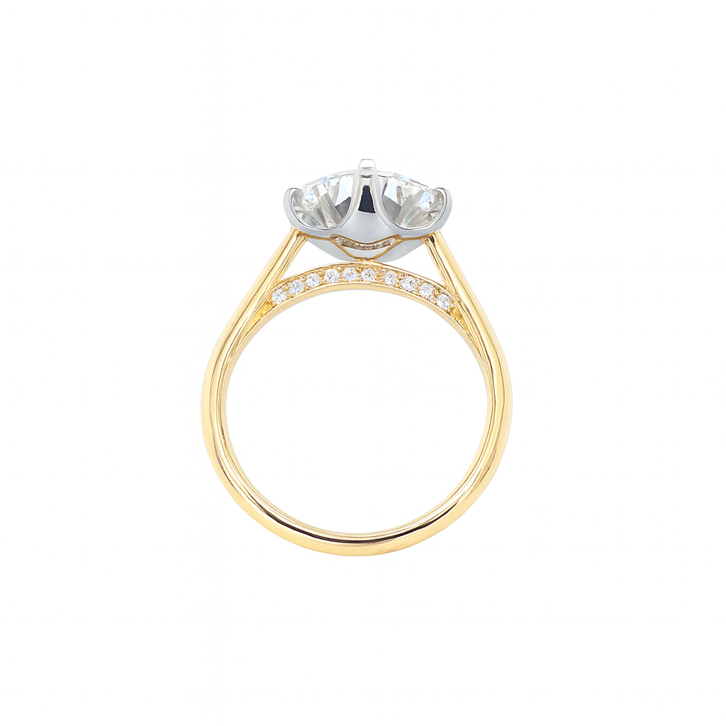 Close-up of 18ct gold and platinum solitaire ring with round lab-grown diamond and hidden diamond detail handmade by Daniel in Hatton Garden London.