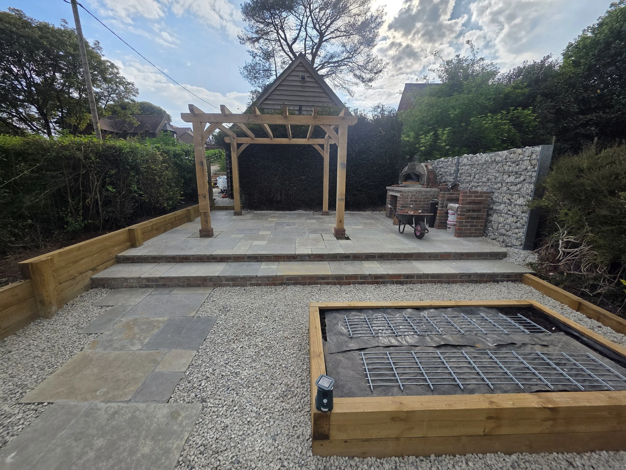 oak pergola and terraced paving