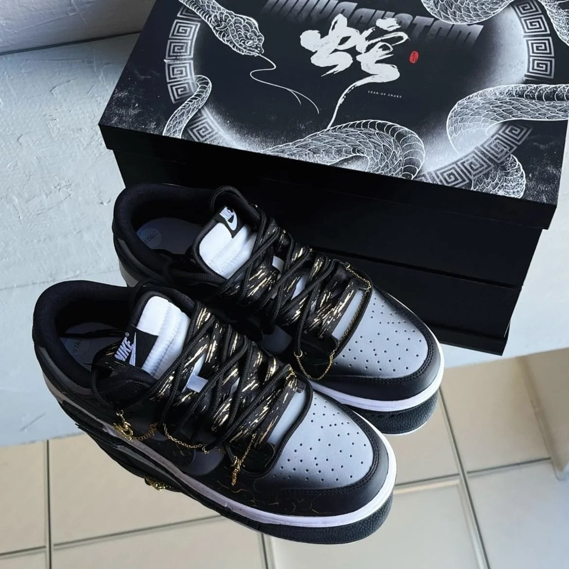 Nike Dunk Low Dragon Vein Custom black and gold sneaker with gold chain and dragon charm.jpeg