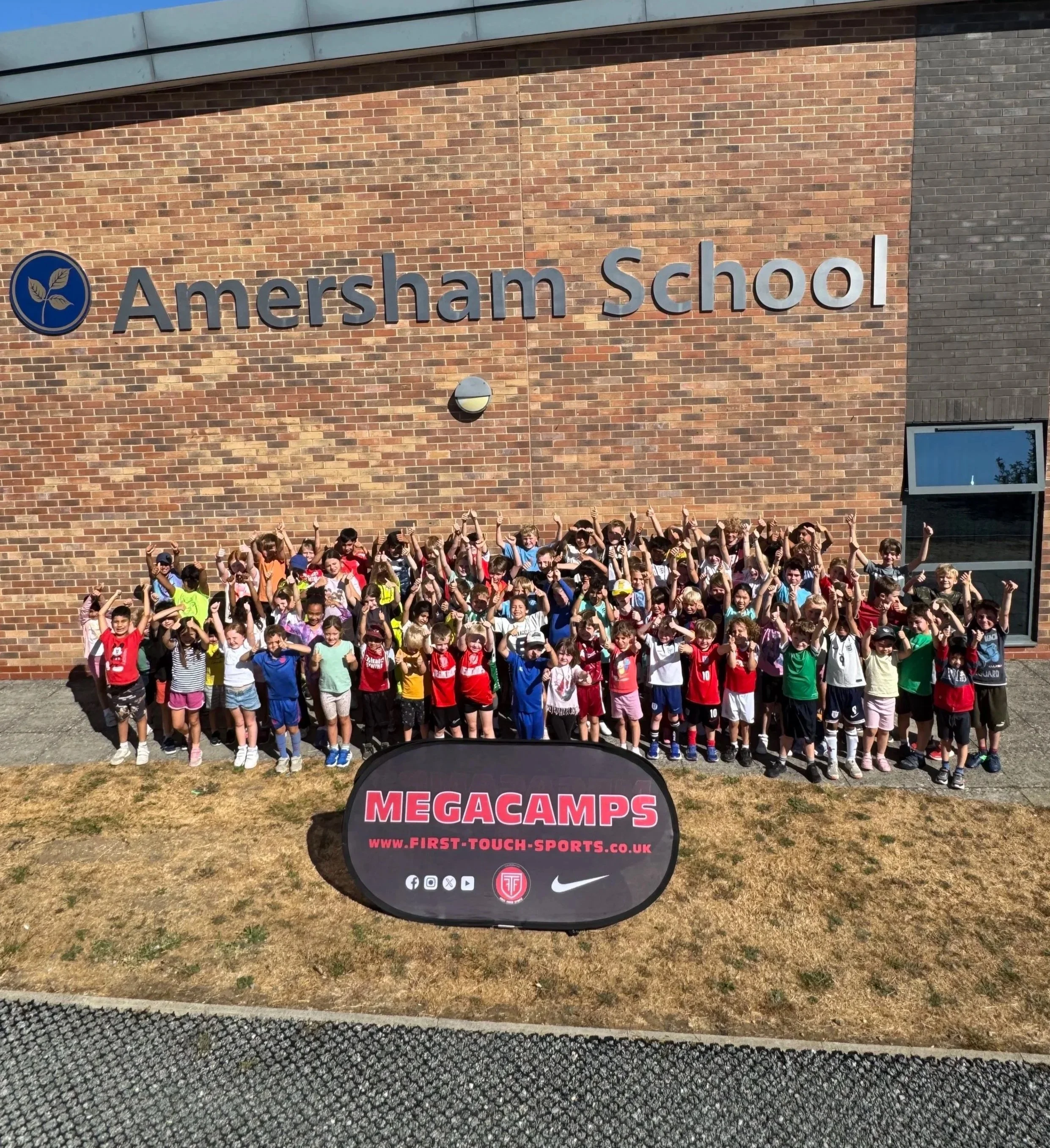 Children gathered on a sports field ready to start First Touch Sports MegaCamp holiday activities in Amersham