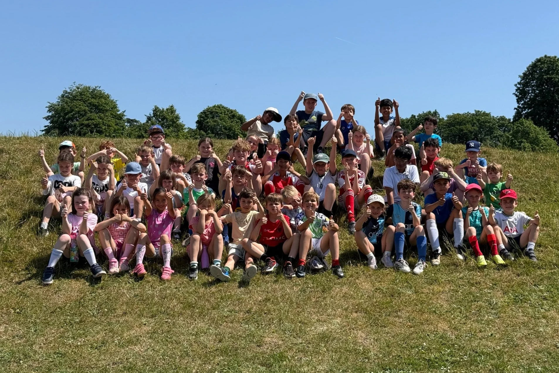 Children gathered on a sports field ready to start First Touch Sports MegaCamp holiday activities in Amersham