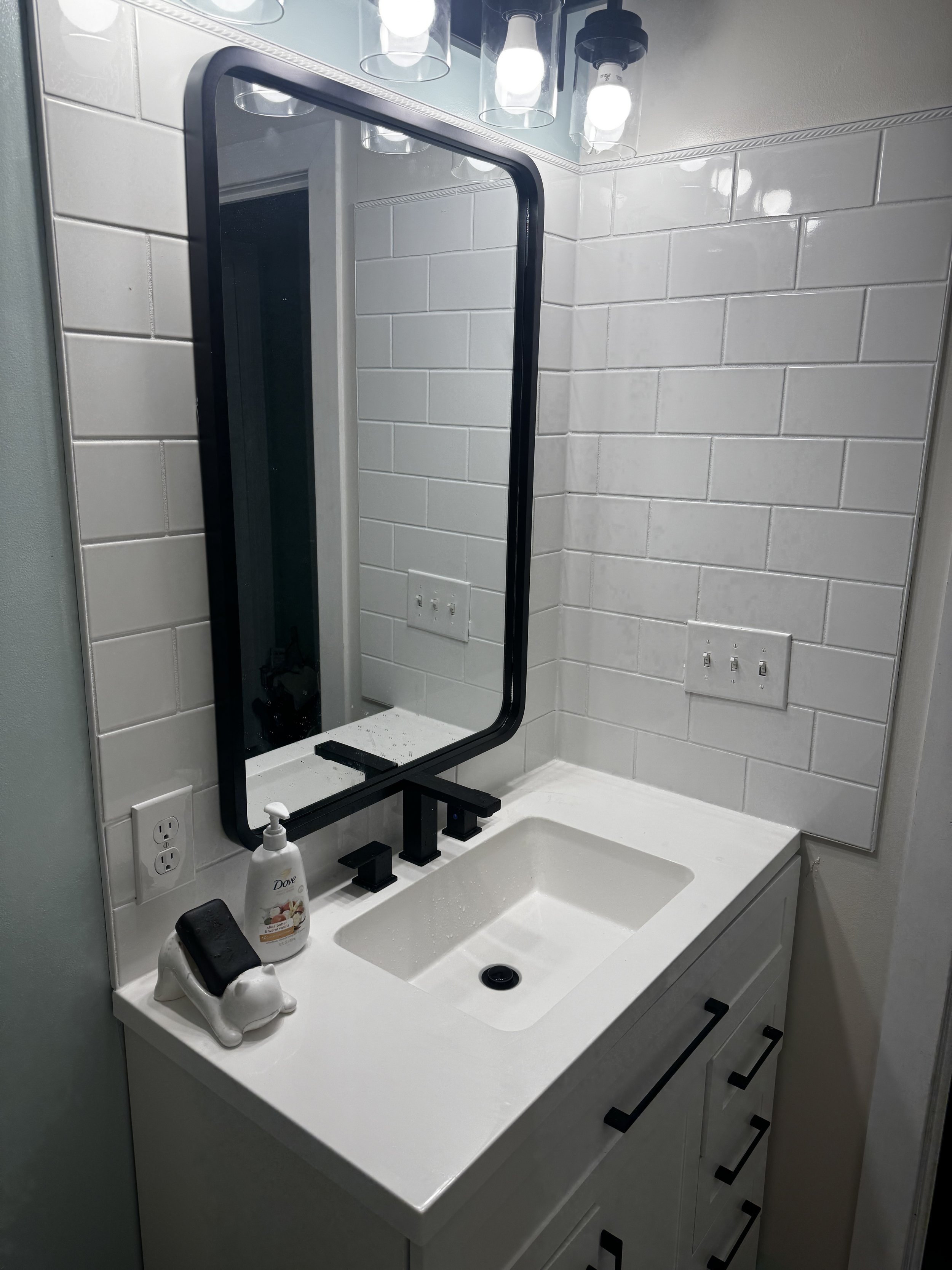 Bathroom tile installation, vanity replacement, and mirror install in Rehoboth Beach, DE by Reyes Renovation