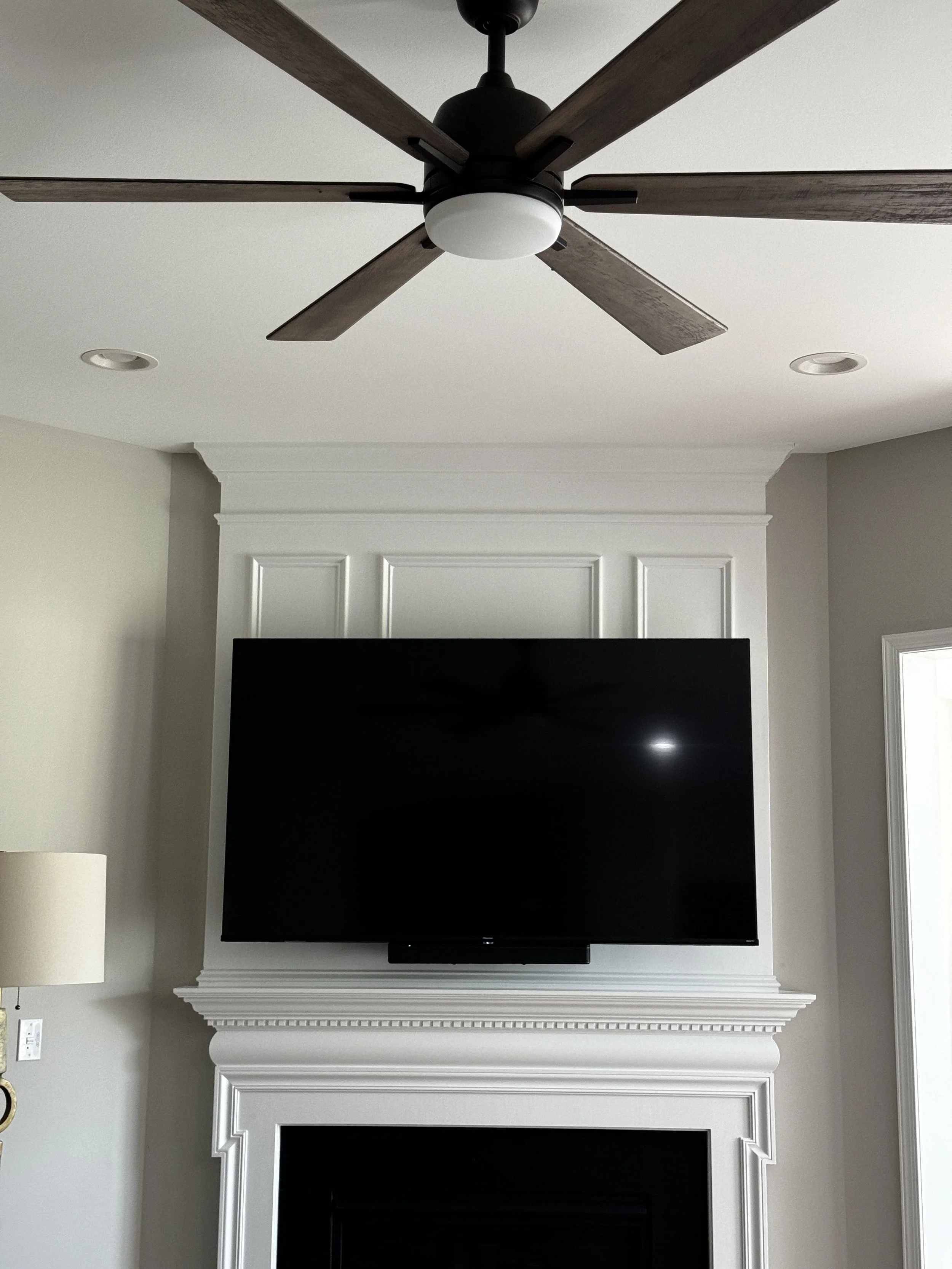 Custom media wall with fireplace and TV installation in Lewes, DE by Reyes Renovation