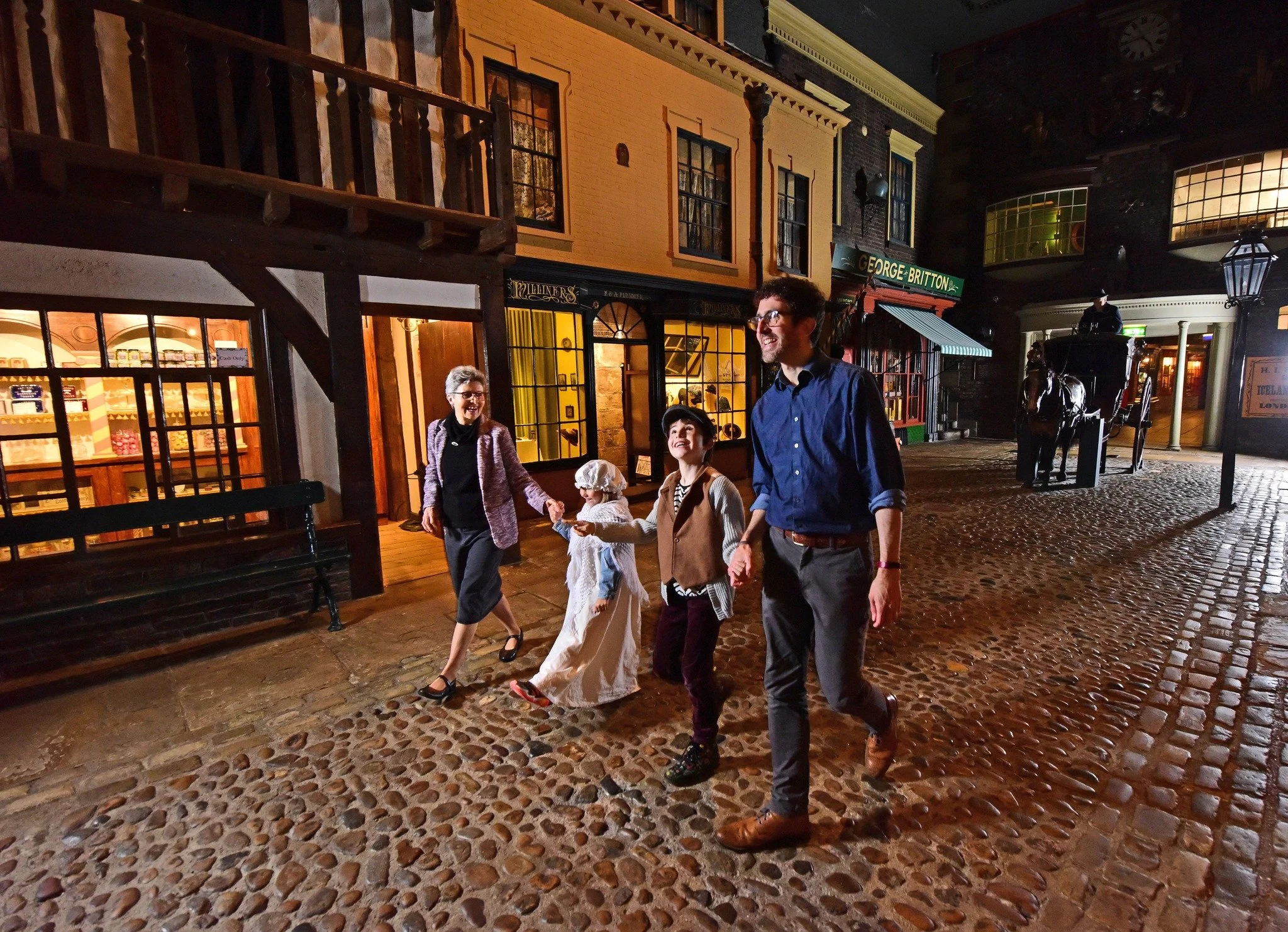 A family walking down the victorian street at Kirkgate in York Castle Museum