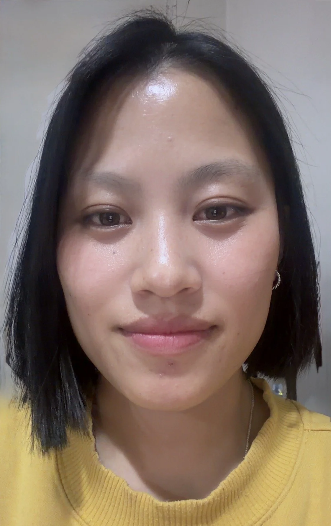Audiologist staff member Nima Zangmo, who has short black hair smiling.