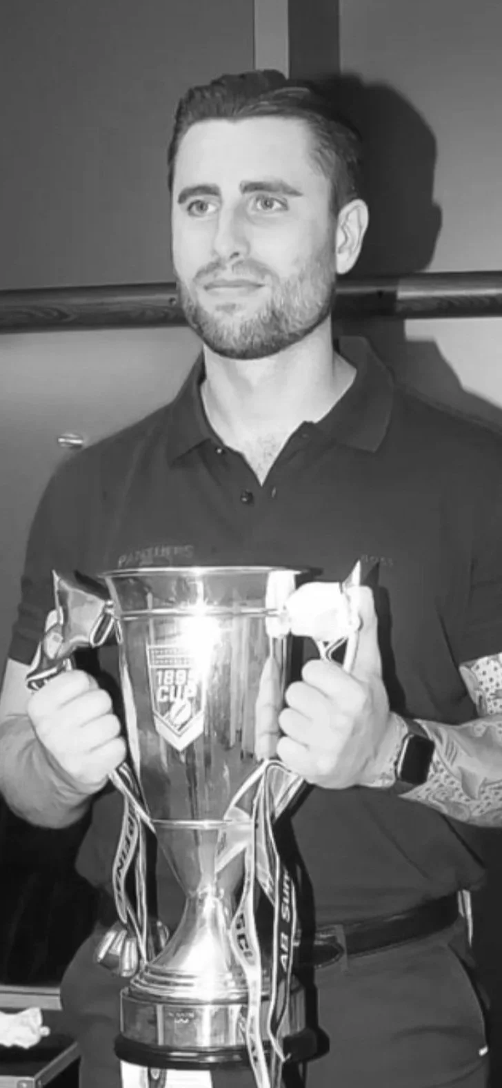 Strength and Conditioning coach - Jon Kelly holding 1895 trophy with both hands at Wembley