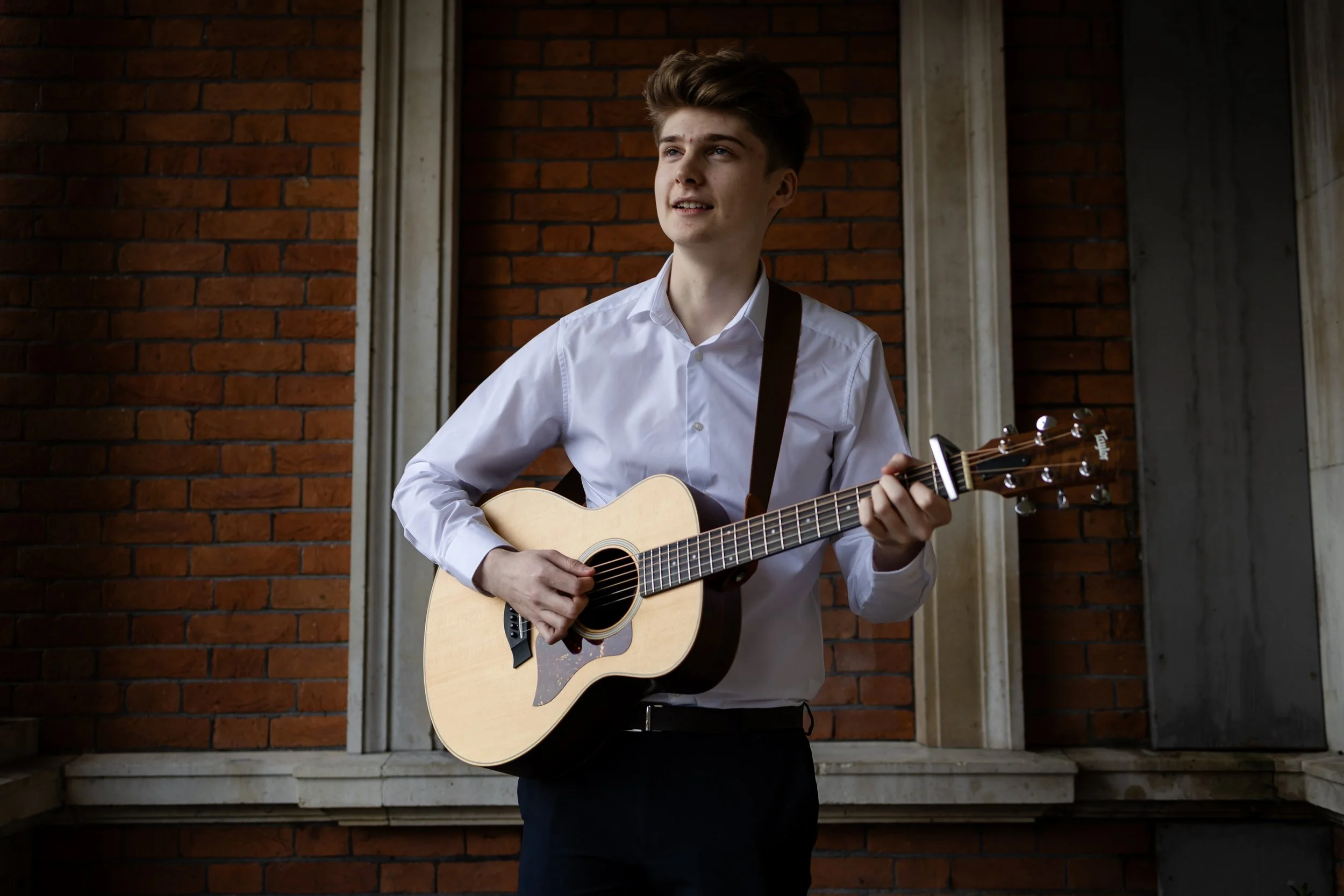 Oscar Flanagan playing acoustic guitar outside