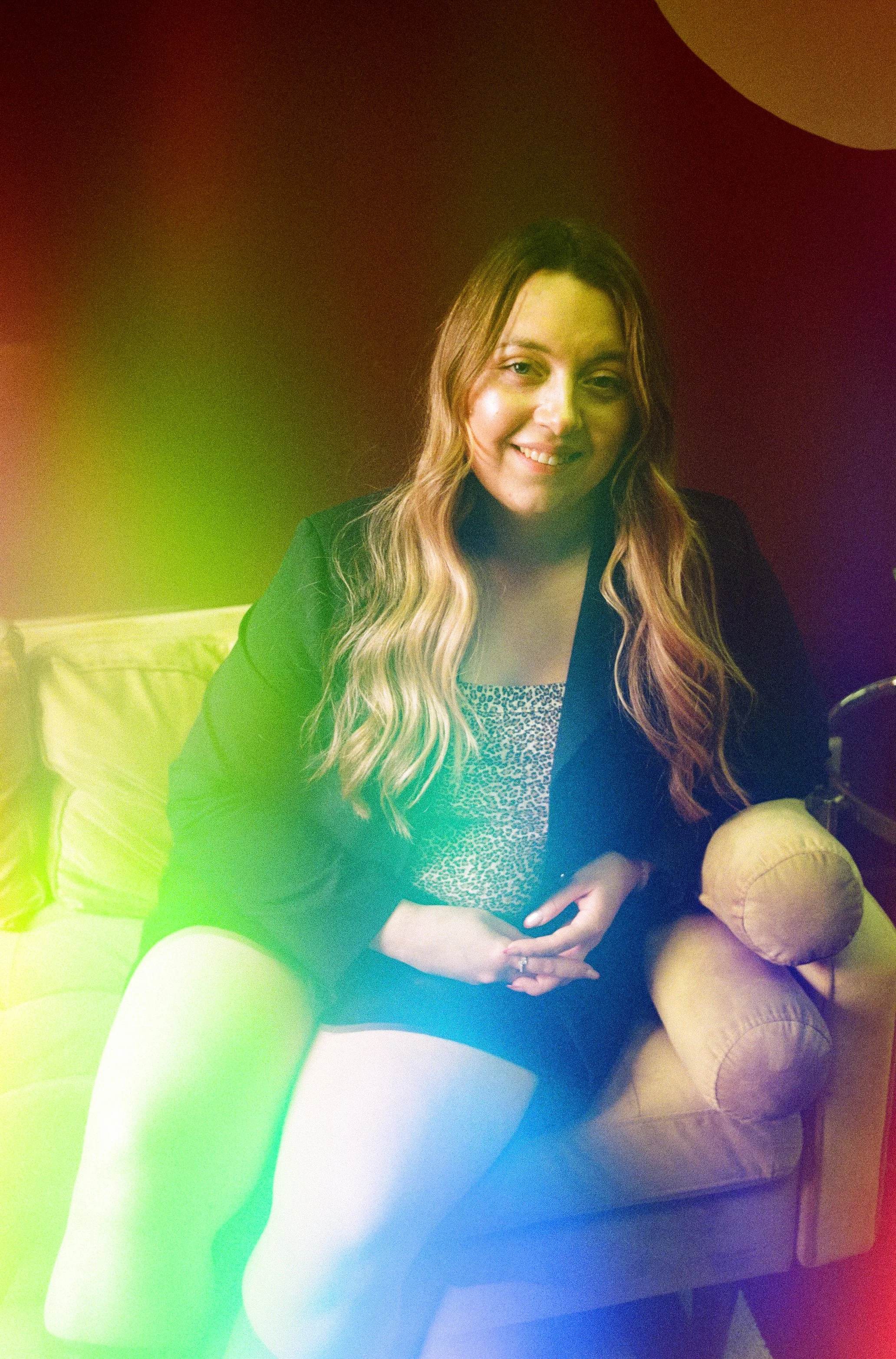 Hair stylist Valerie sits on a couch