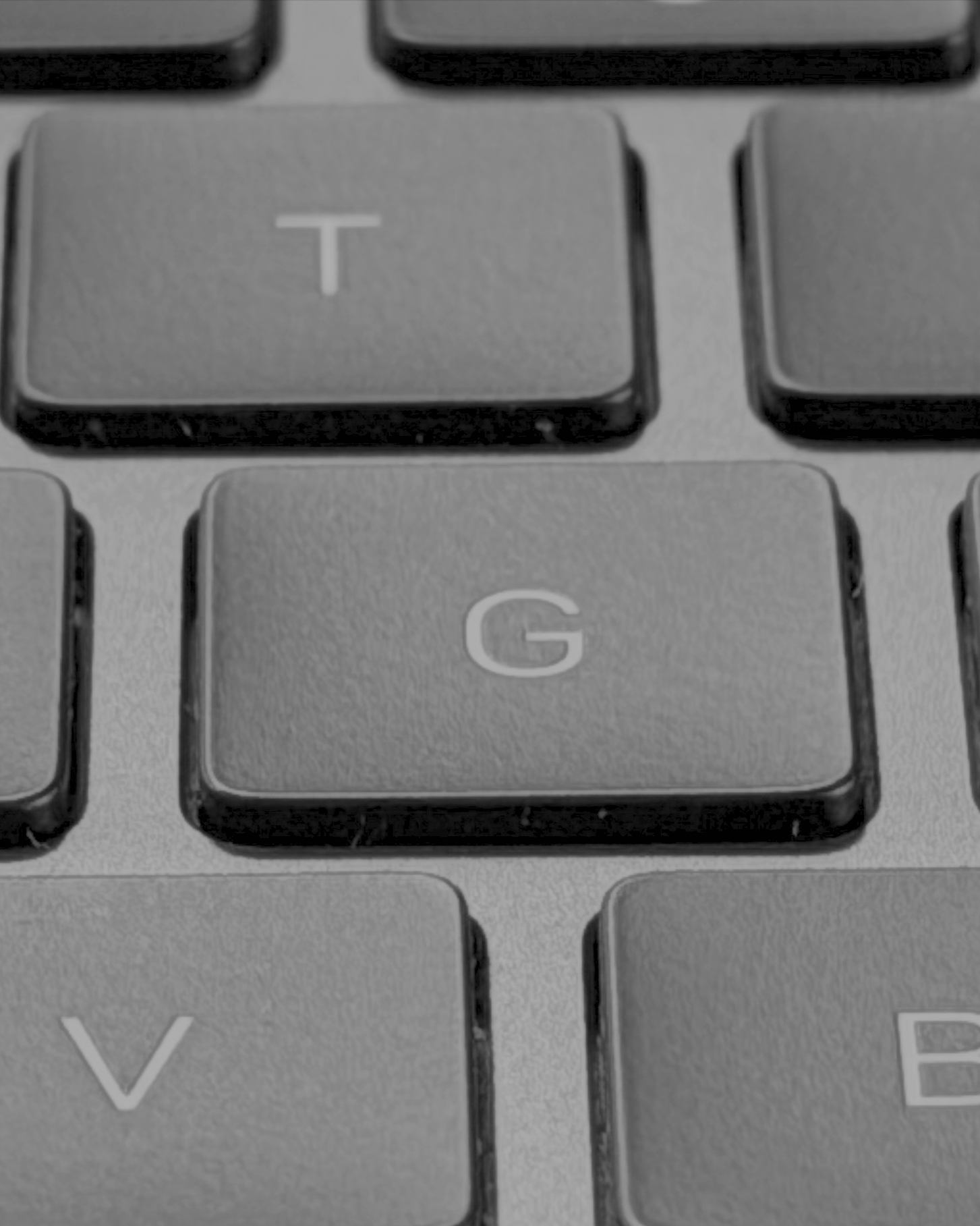 Close-up of a computer keyboard showing the G key and surrounding keys, including T and V.