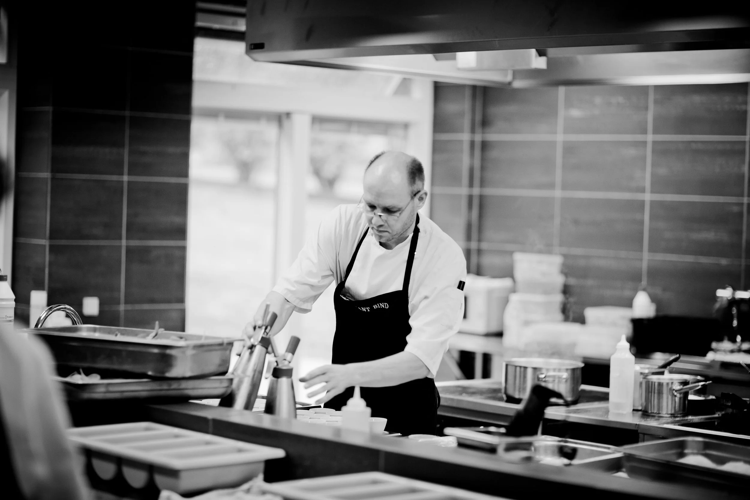 Head Chef managing busy restaurant kitchen brigade in the UK