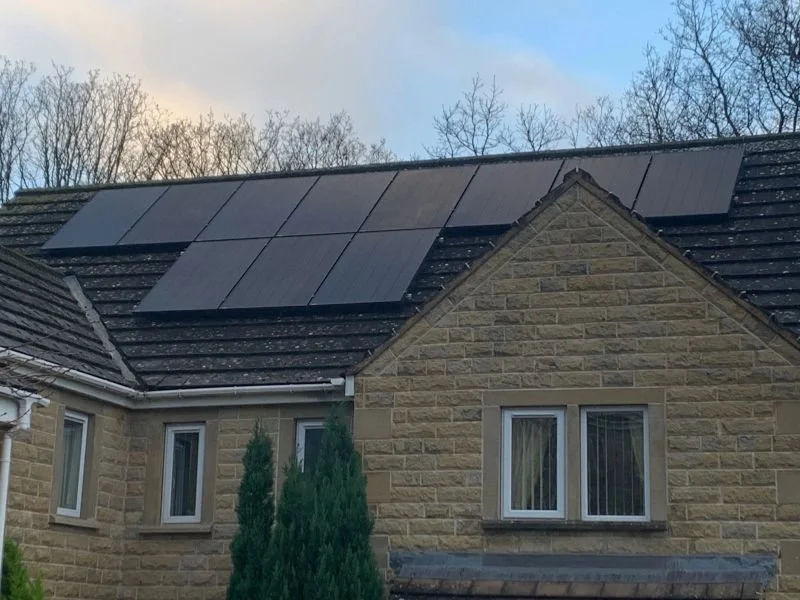 A house with solar panels installed on the roof.