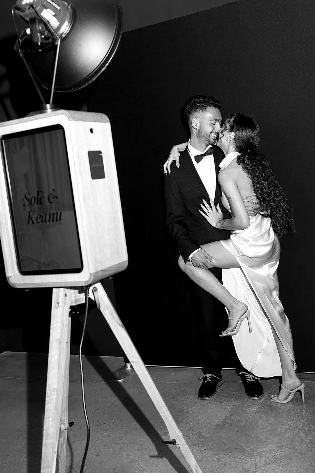 Timeless black and white portrait of a wedding couple captured at a luxury photo booth rental.
