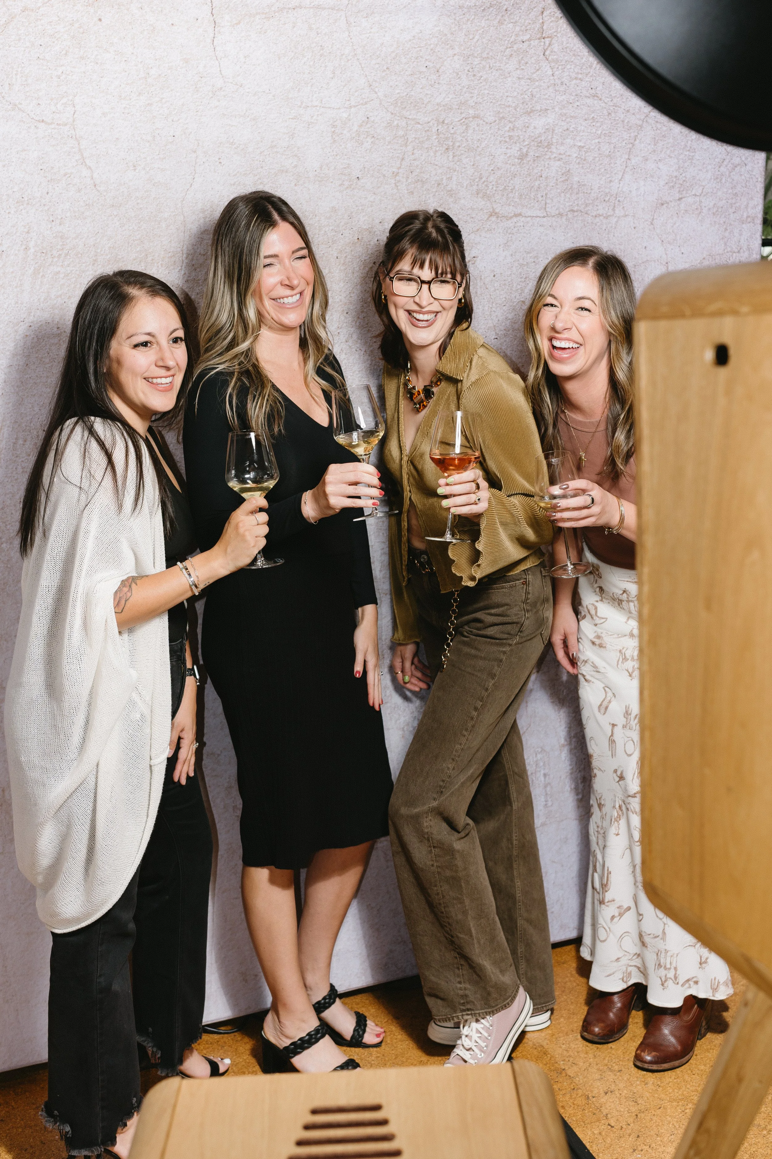 Guests celebrating together at a luxury photo booth experience during an upscale party or event.