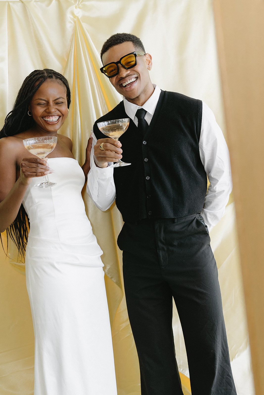Outdoor event with tables and umbrellas reflected in a wooden photo booth camera