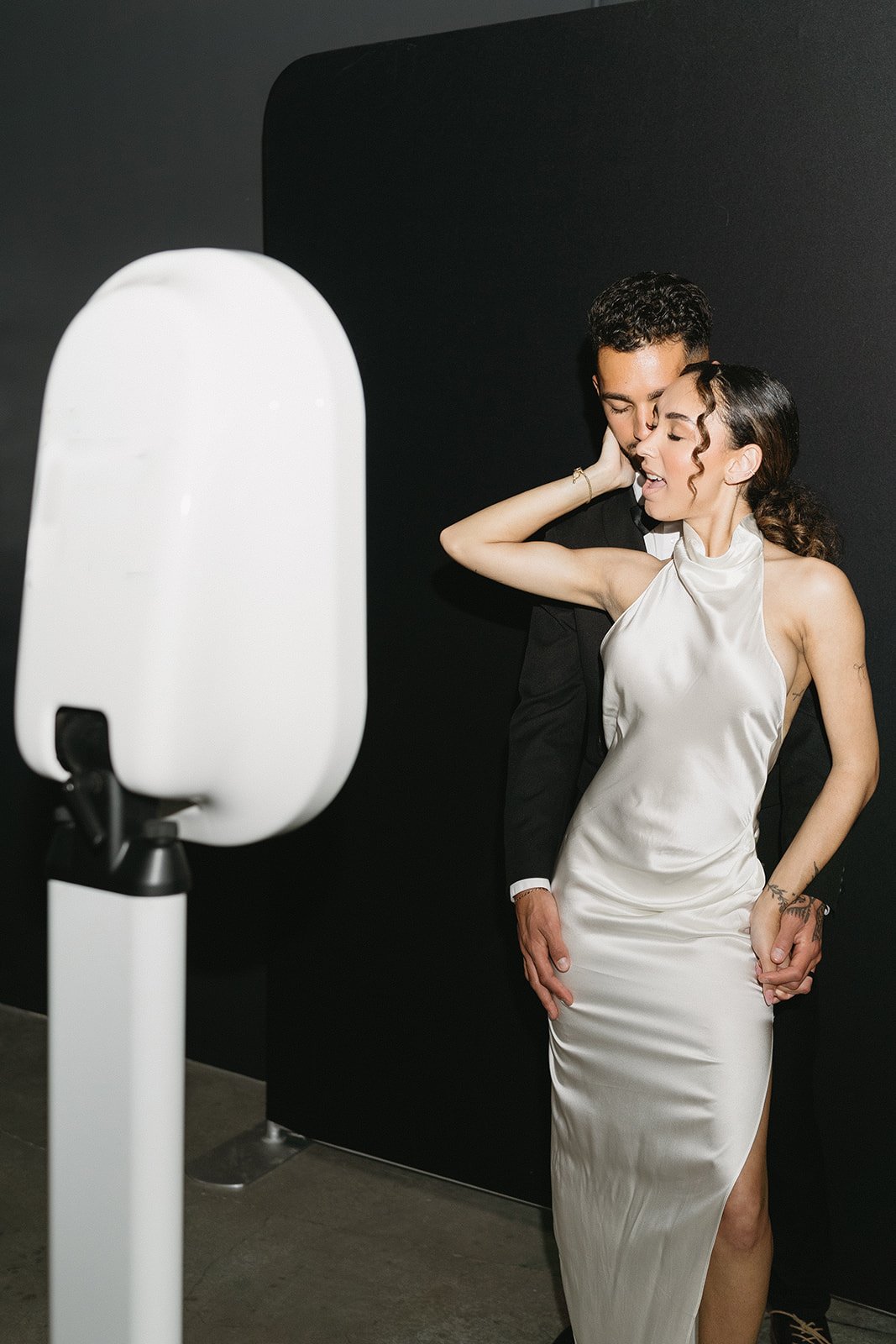Wedding couple enjoying a luxury photo booth experience during an elegant evening reception.