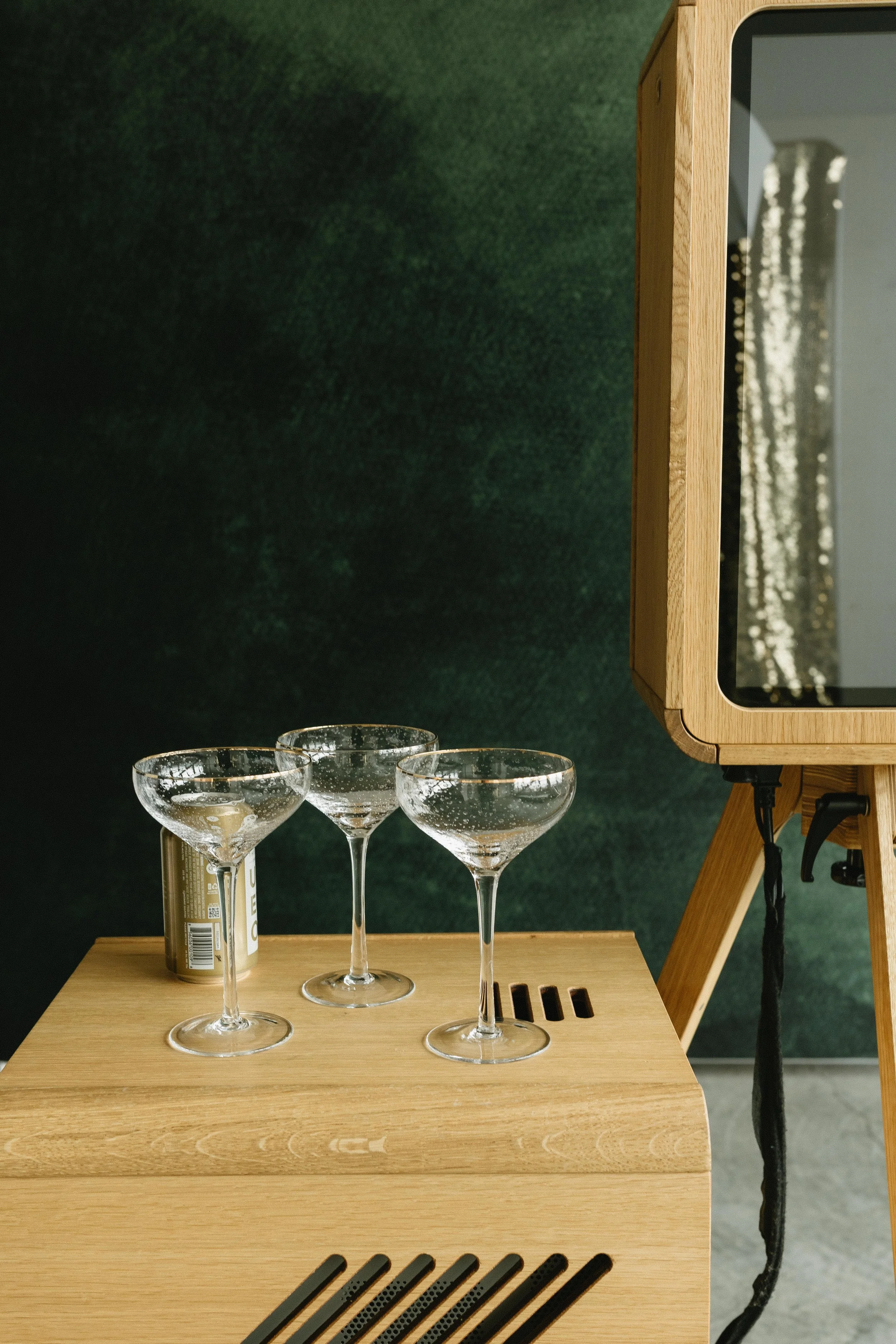 Styled cocktail table detail beside a luxury photo booth setup at a wedding reception.