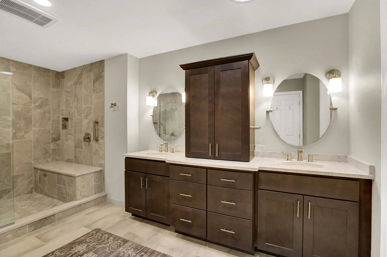  Spacious bathroom in warm wood tones and neutral tiles with open shower, double vanity, and toilet closet, design and constructed by Connor Design-Build, Harrisburg 