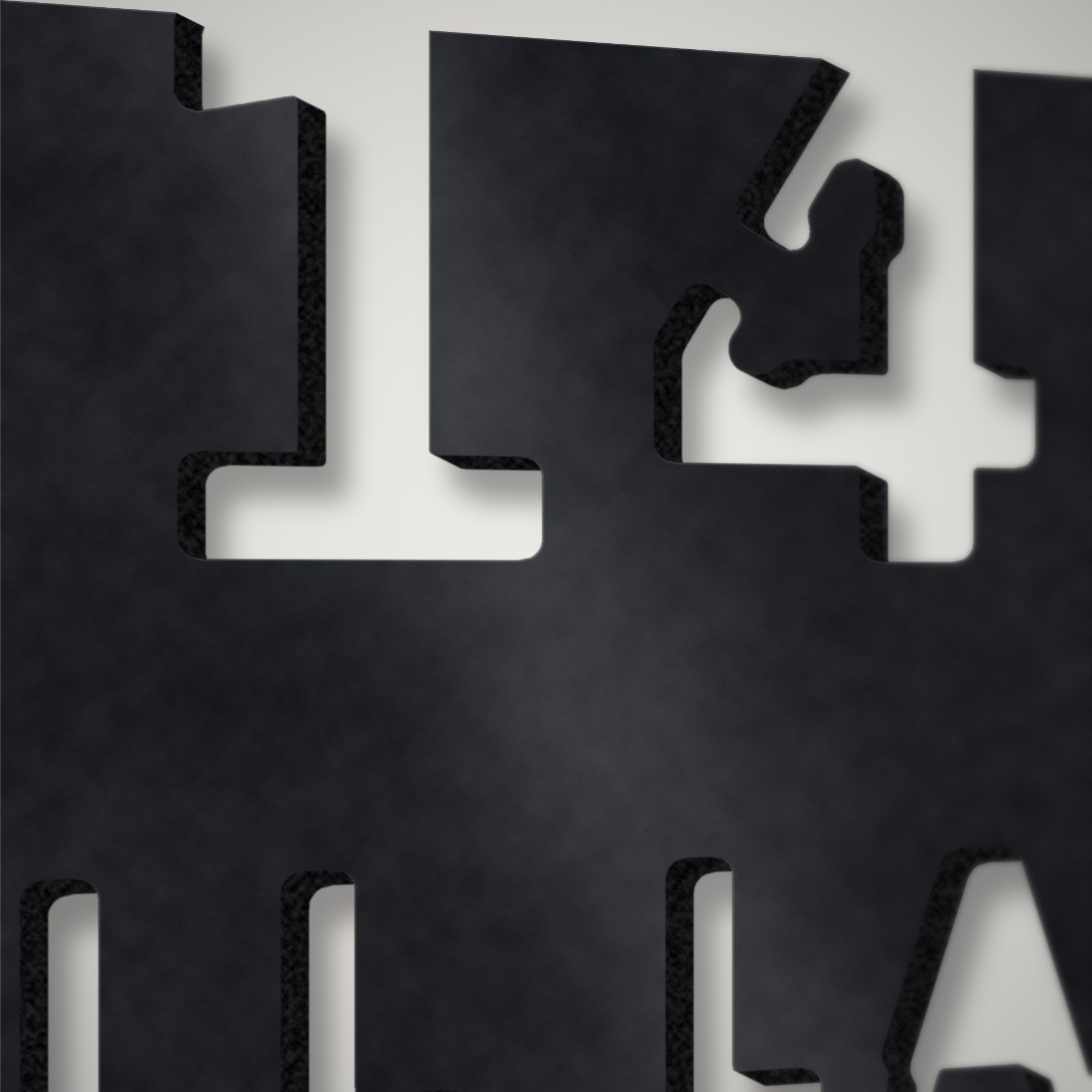 Close-up of stencil street-name lettering plasma-cut through 3 mm steel showing the cut edge