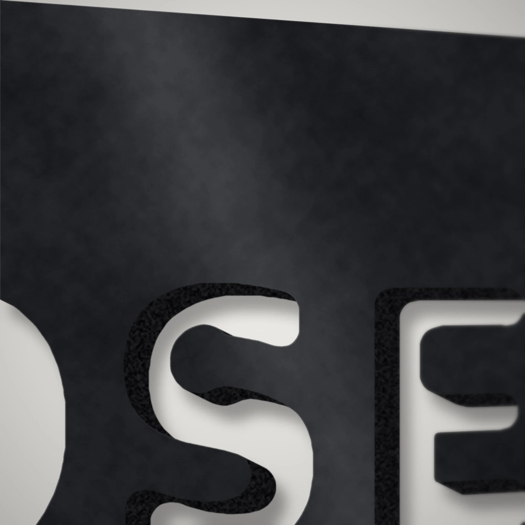 Close-up of stencil letters plasma-cut through 3 mm steel showing the cut edge