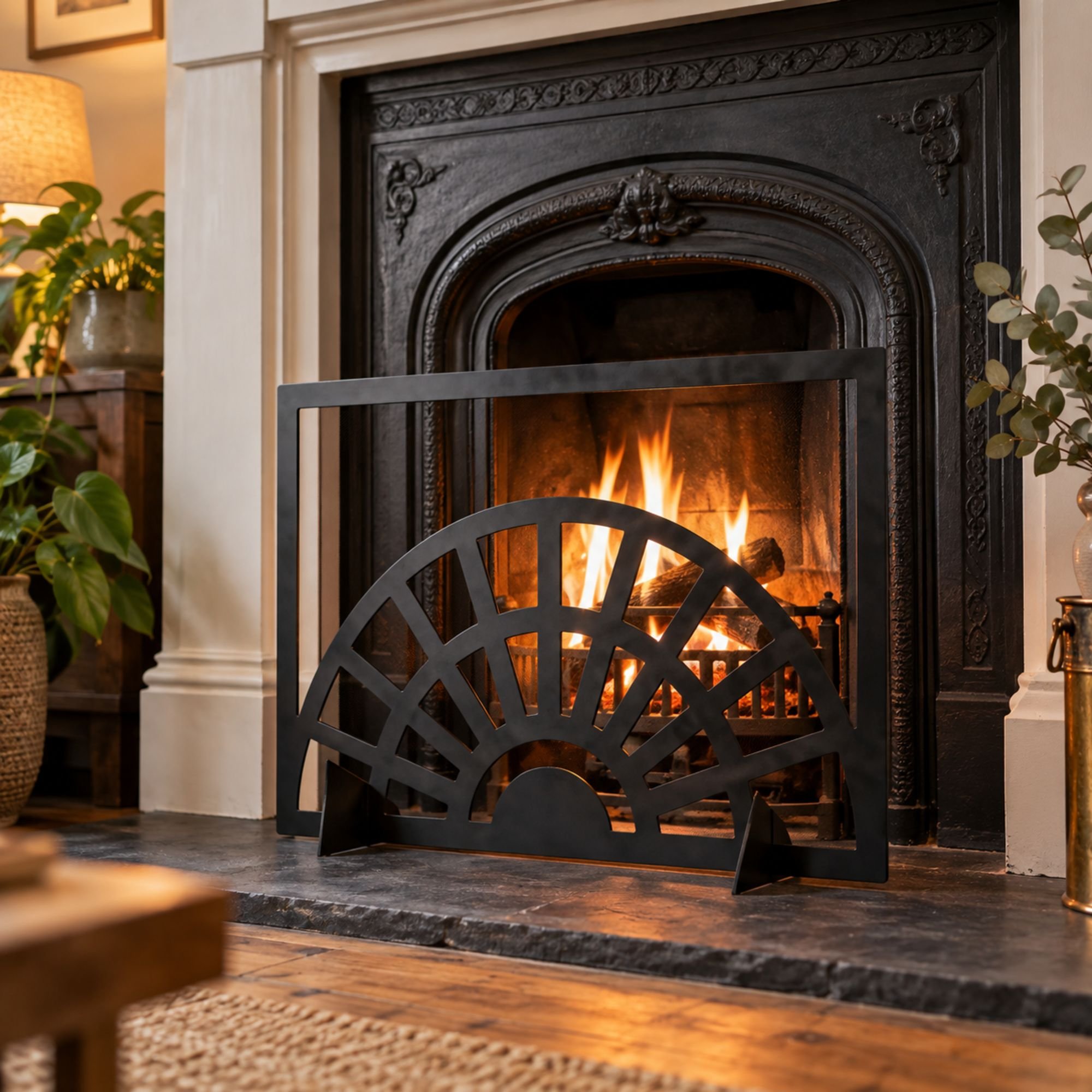Ember Art Deco Fireplace Screen in satin black, standing on a slate hearth in front of an original cast iron fireplace in a UK 1930s semi living room