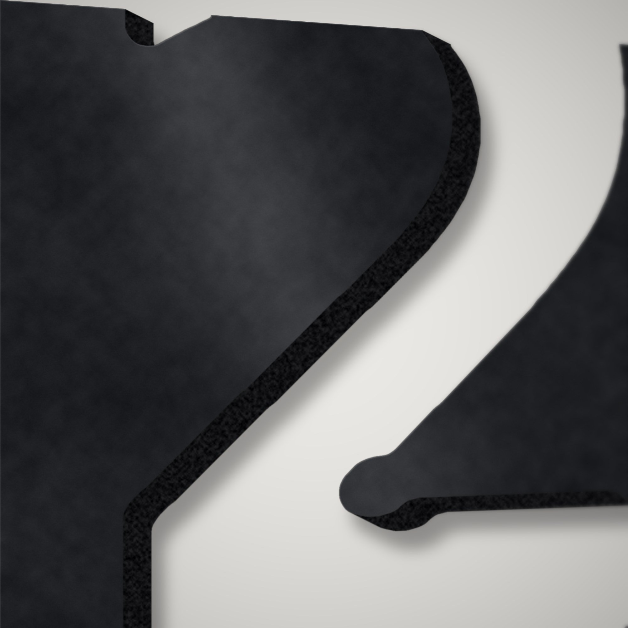 Close-up of a stencil numeral plasma-cut through 3 mm steel showing the clean cut edge