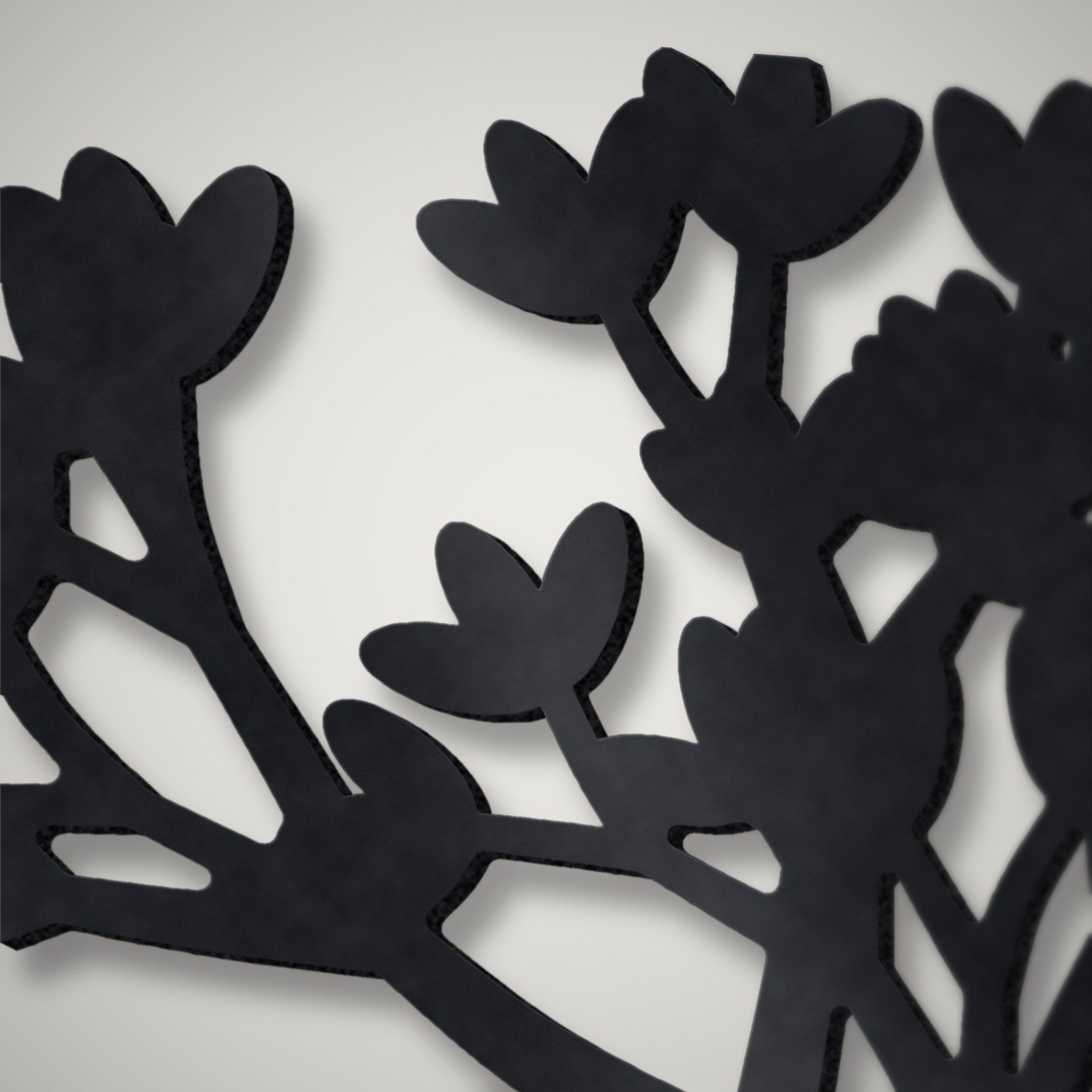 Close-up of plasma-cut leaves and stencil lettering on a 3 mm steel family tree