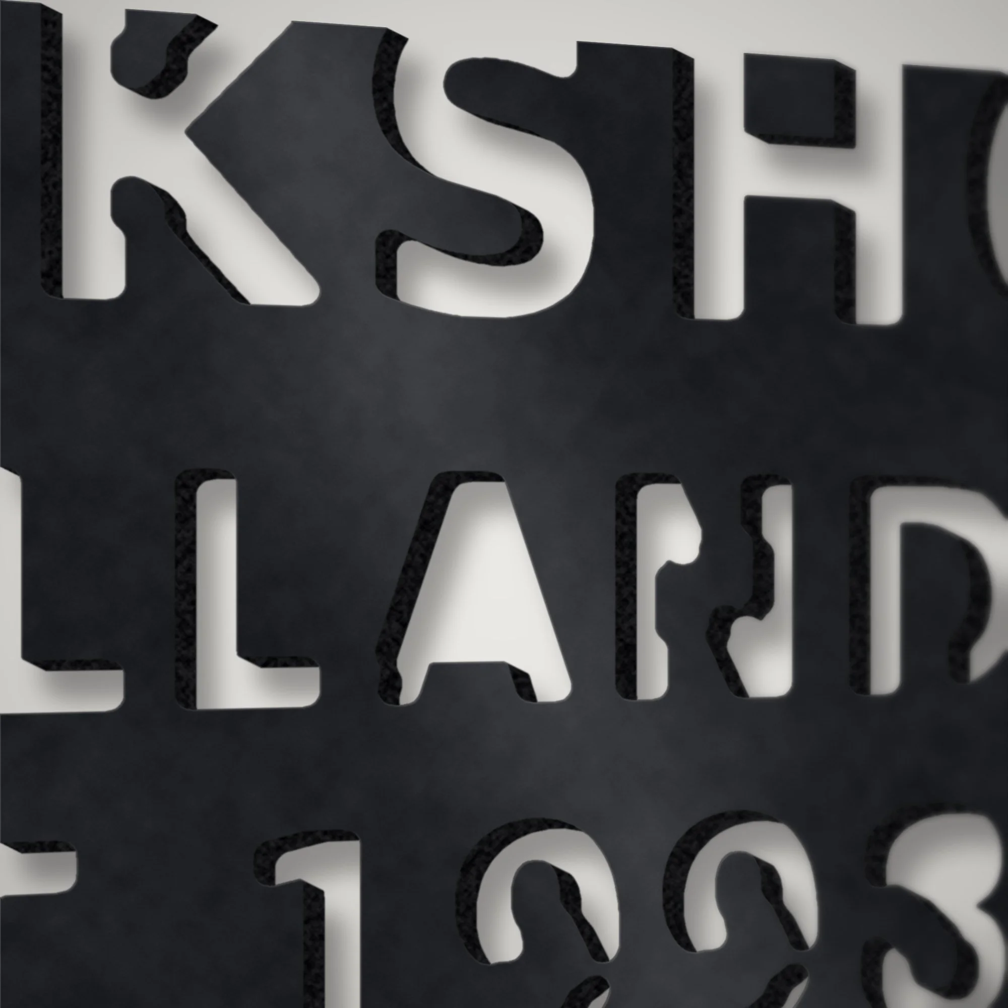 Close-up of plasma-cut stencil numerals on a 3 mm steel workshop sign