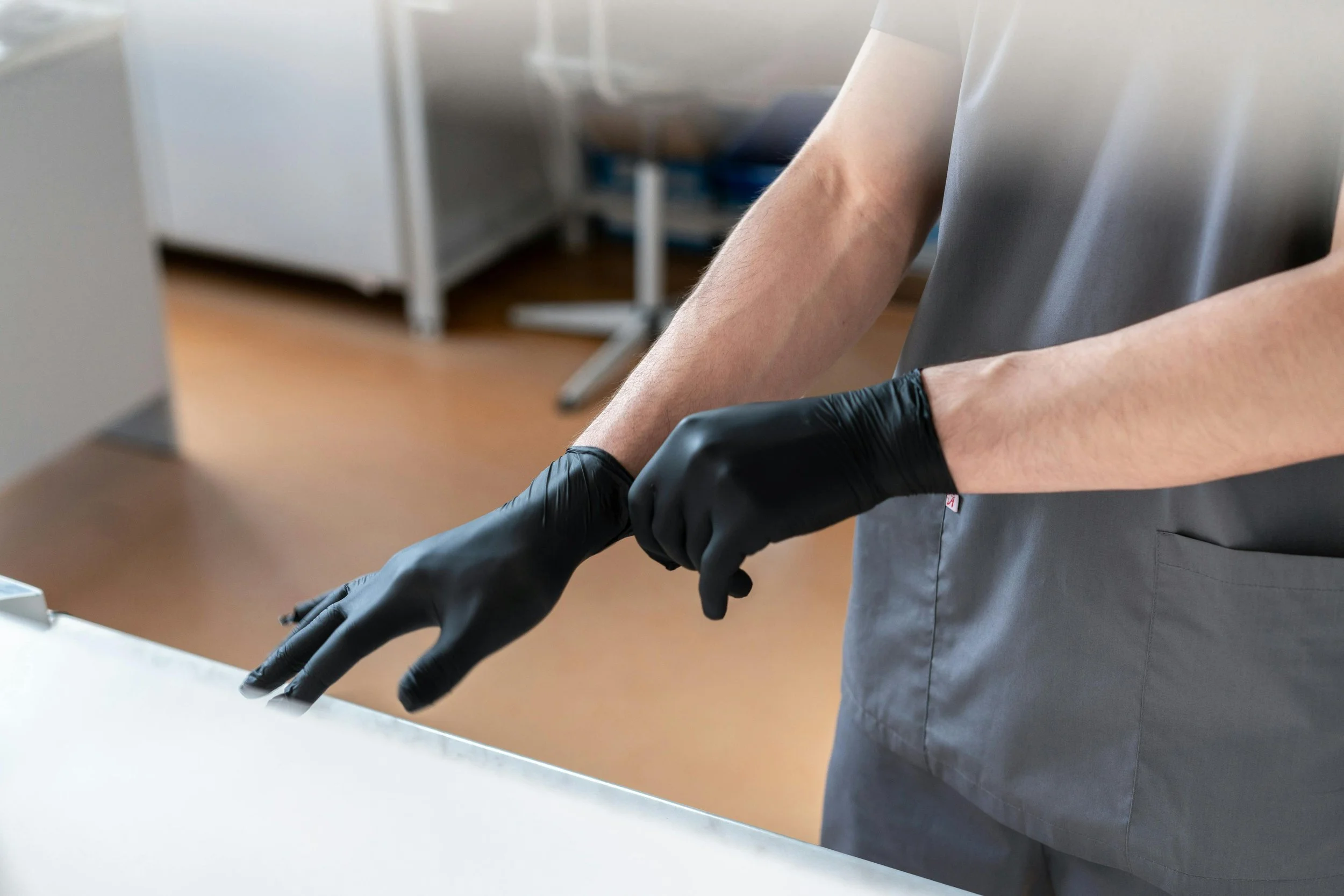 Person wearing black gloves in a security setting