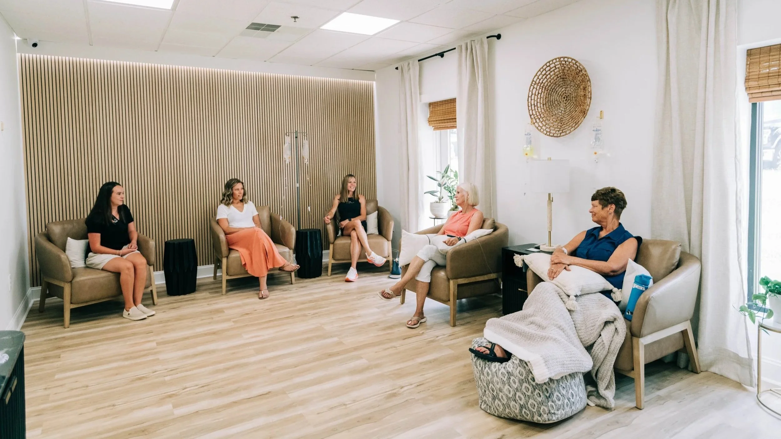 Adult patient relaxing during an IV in the Raleigh Well lounge