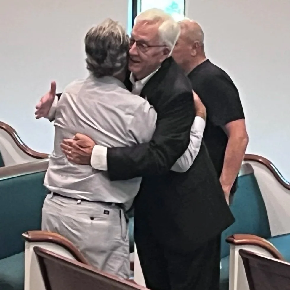 Members greeting one another with a warm embrace at Powell Road Church of Christ