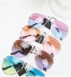 Six pairs of colorful sunglasses arranged in a row on a white surface.