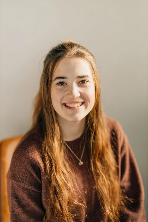 Fiona, smiling, wearing a maroon sweater
