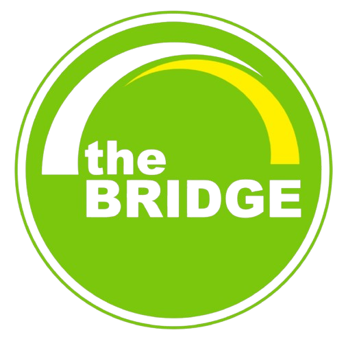 A circular logo with a green background, black text that reads 'the BRIDGE', and a yellow curved line at the top.